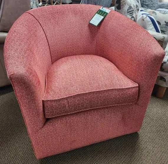 a red chair sitting in a room filled with furniture