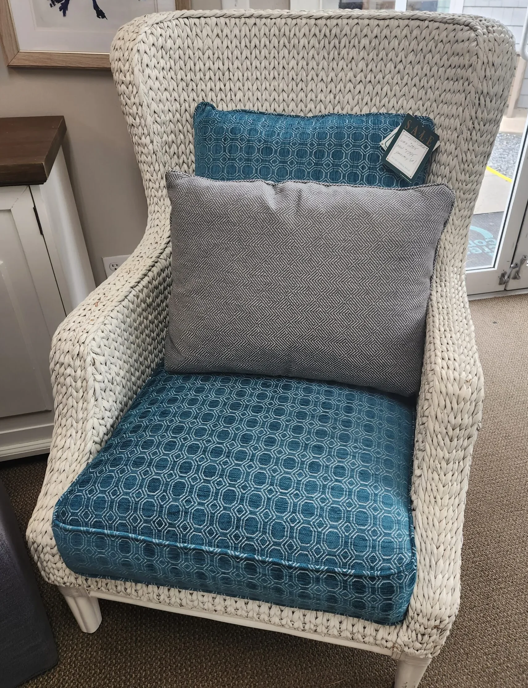 a chair with a pillow on it in a room