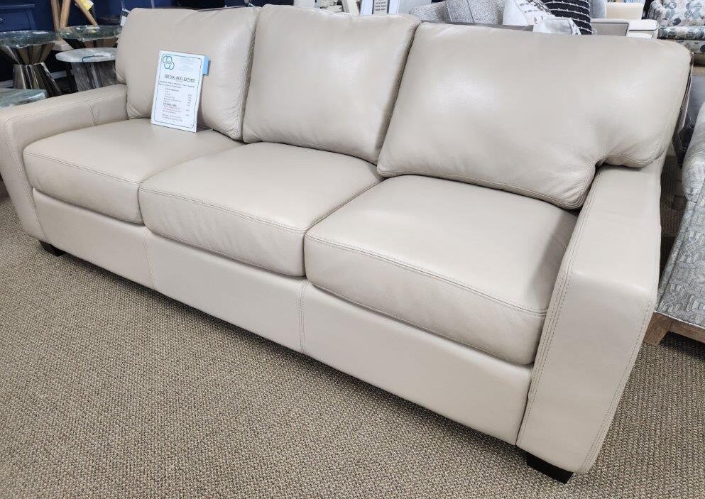 a white leather couch in a store