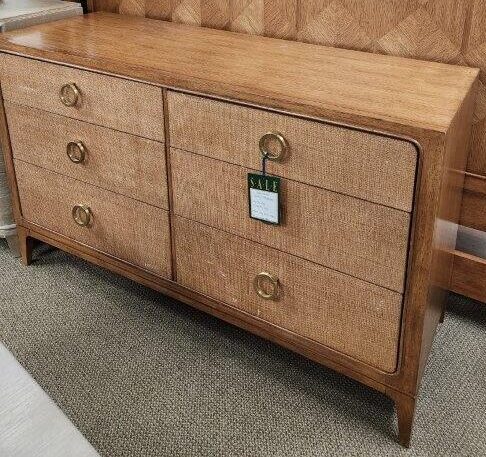 a bed with a wooden headboard and drawers