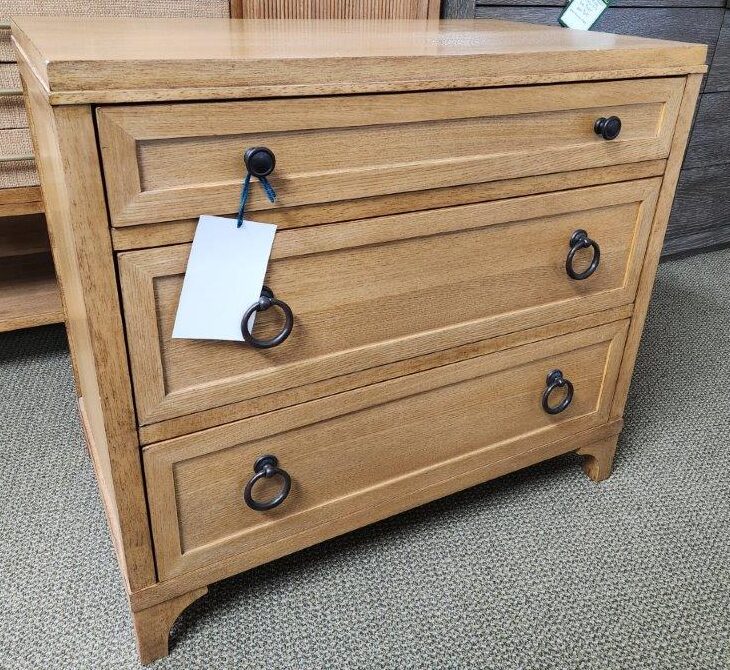 a wooden dresser sitting on top of a carpeted floor
