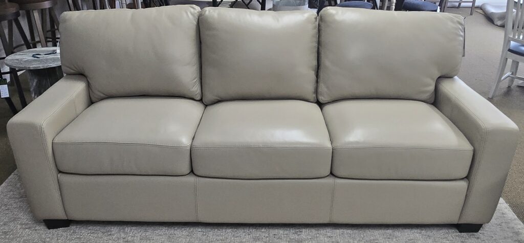 Thumbnail of http://a%20white%20leather%20couch%20sitting%20on%20top%20of%20a%20rug