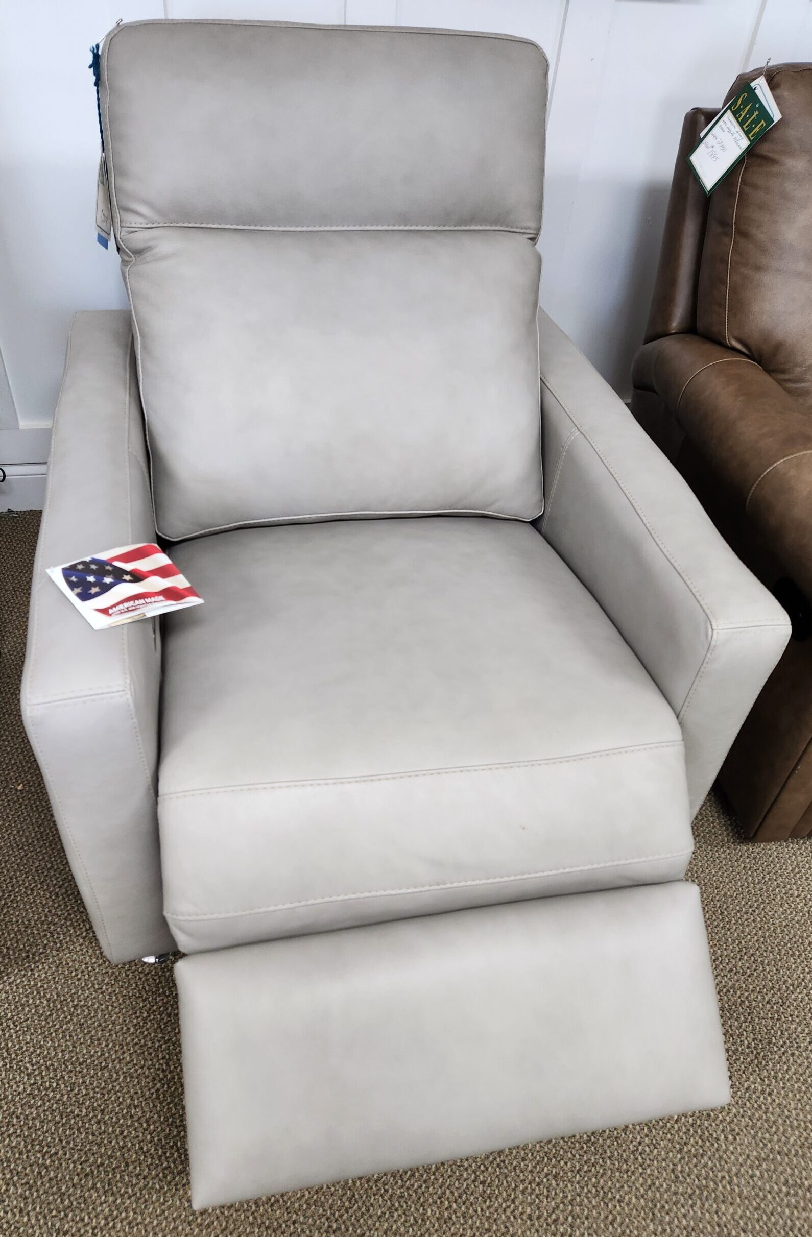 a living room with a couch, chair and ottoman
