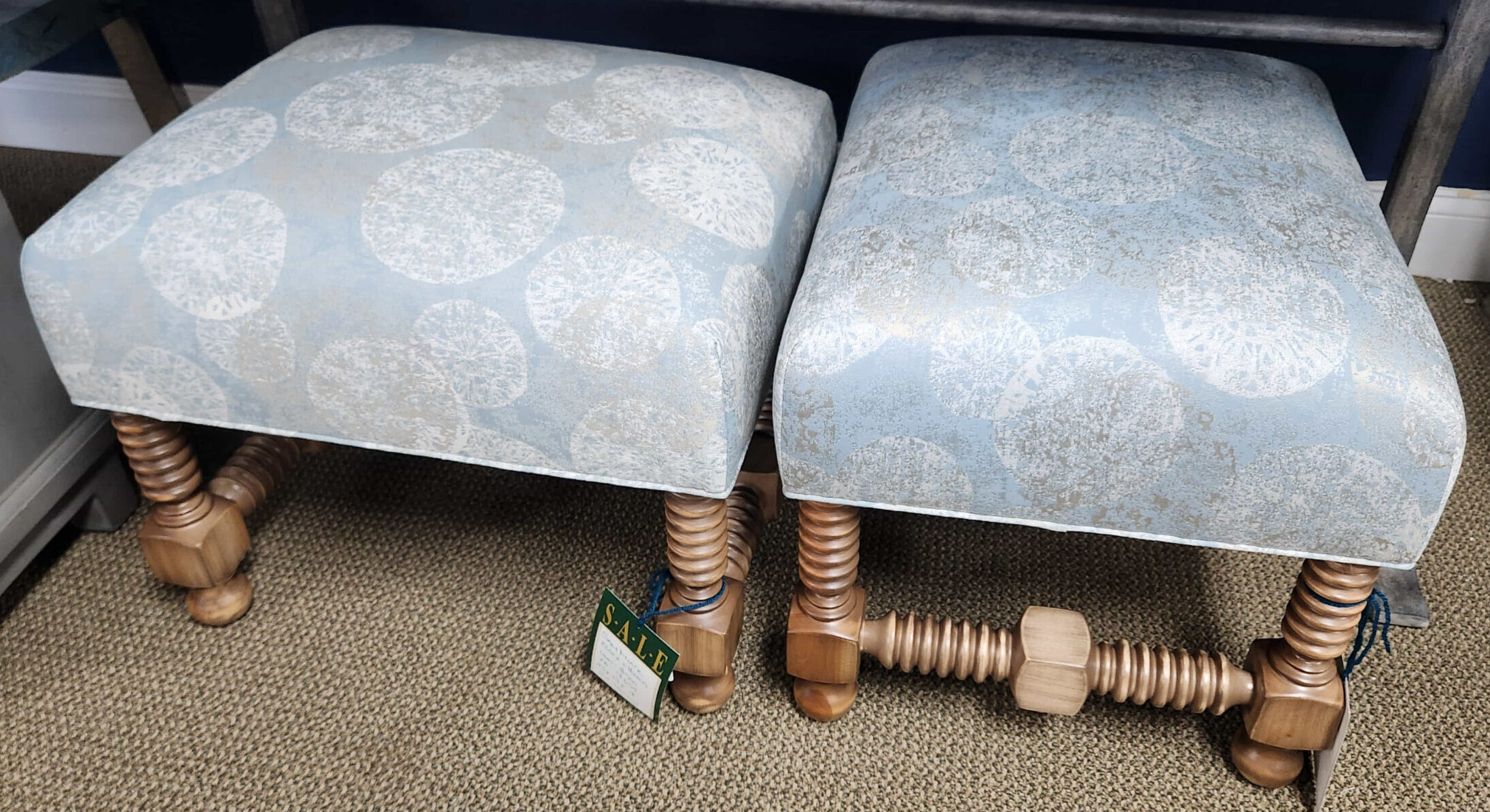 a pair of foot stools sitting under a desk