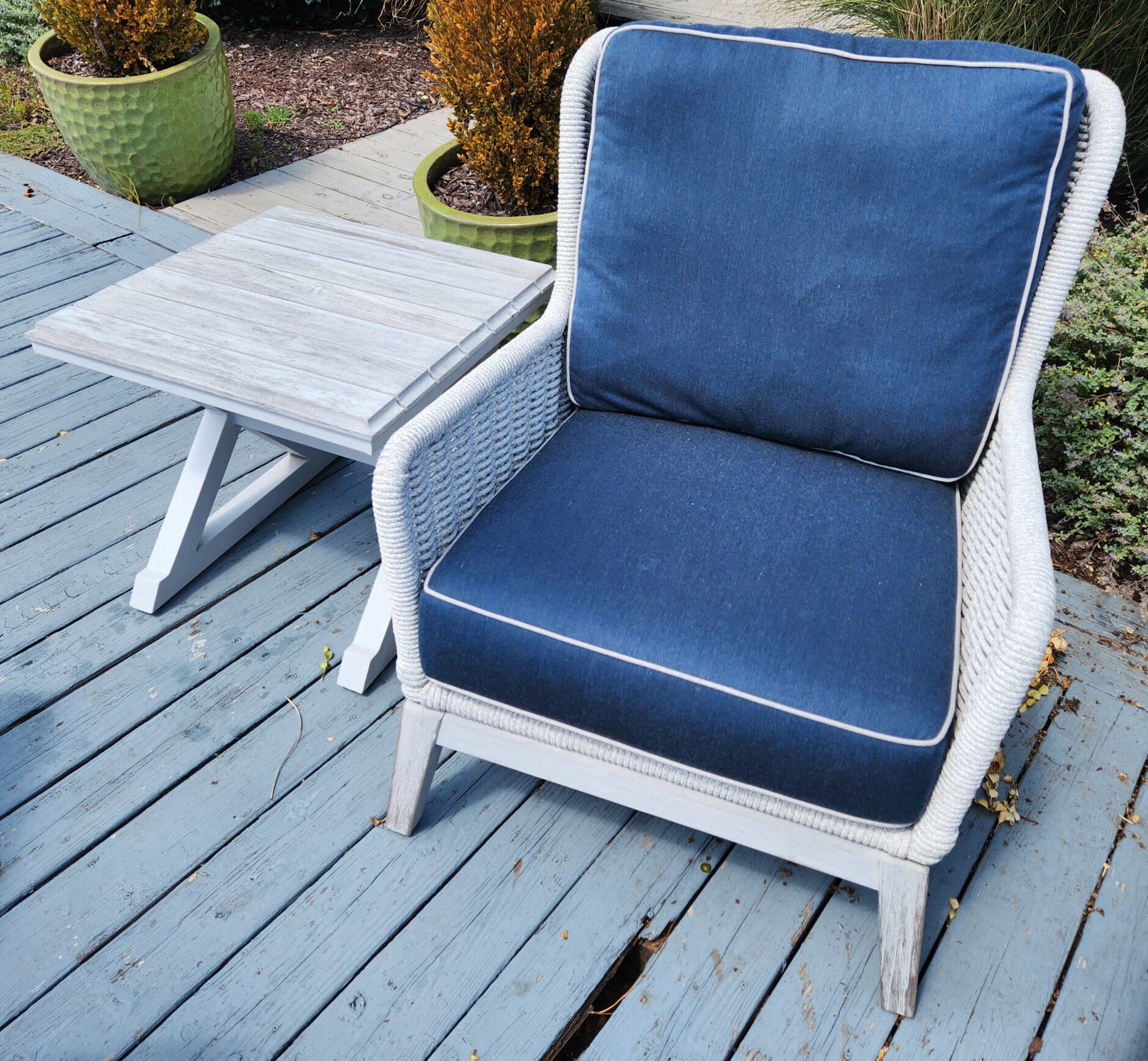 a blue chair sitting on top of a wooden deck