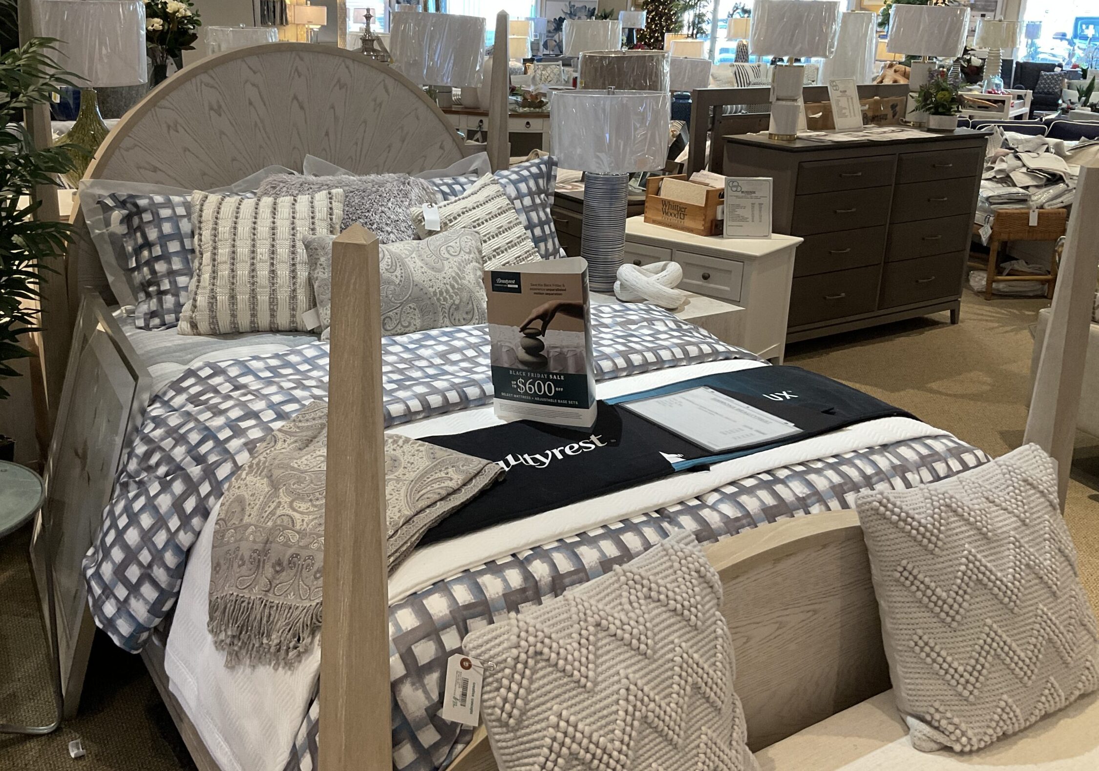 a bed room with a neatly made bed and lots of furniture