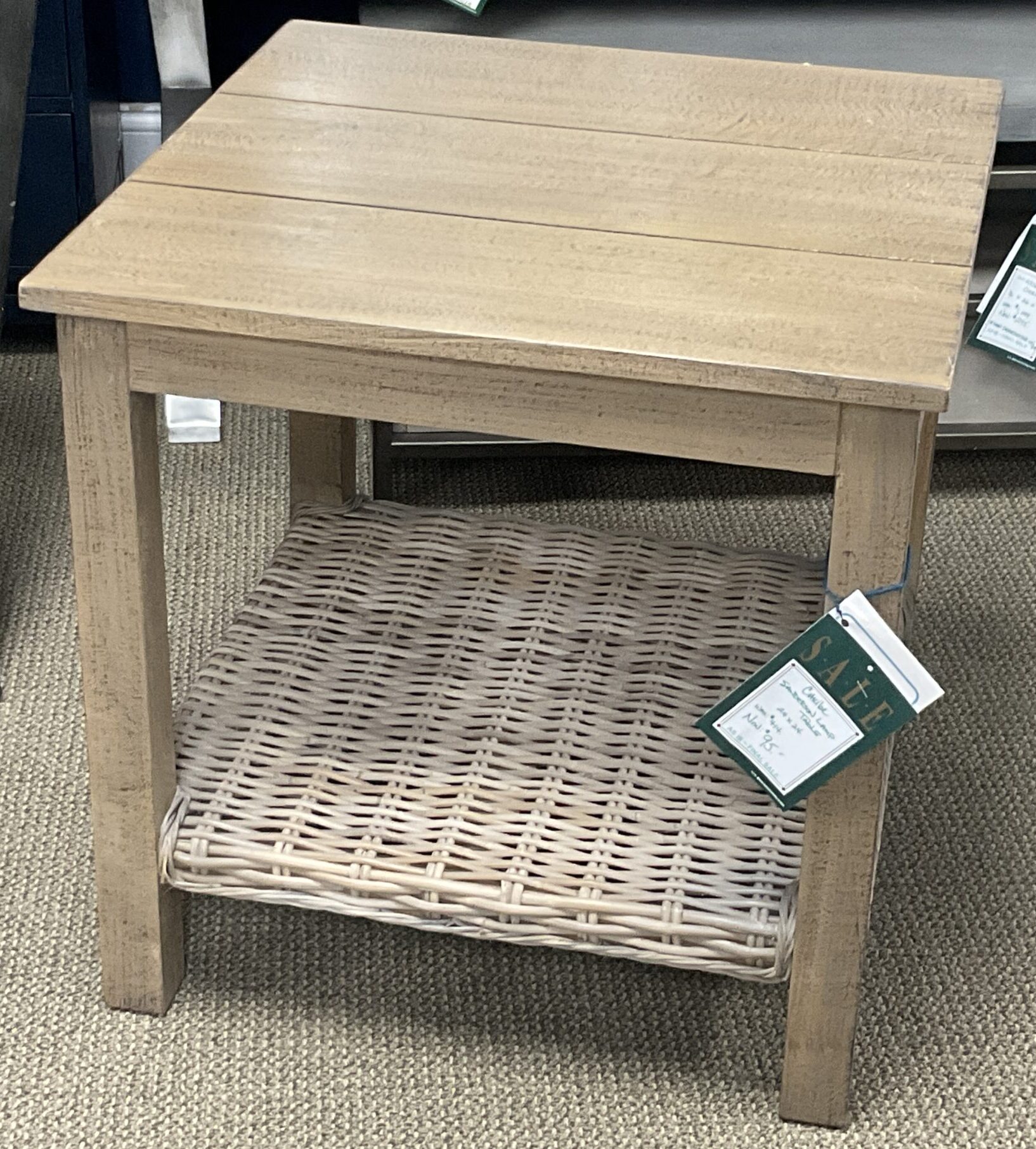 a wooden table with tags on it in a store