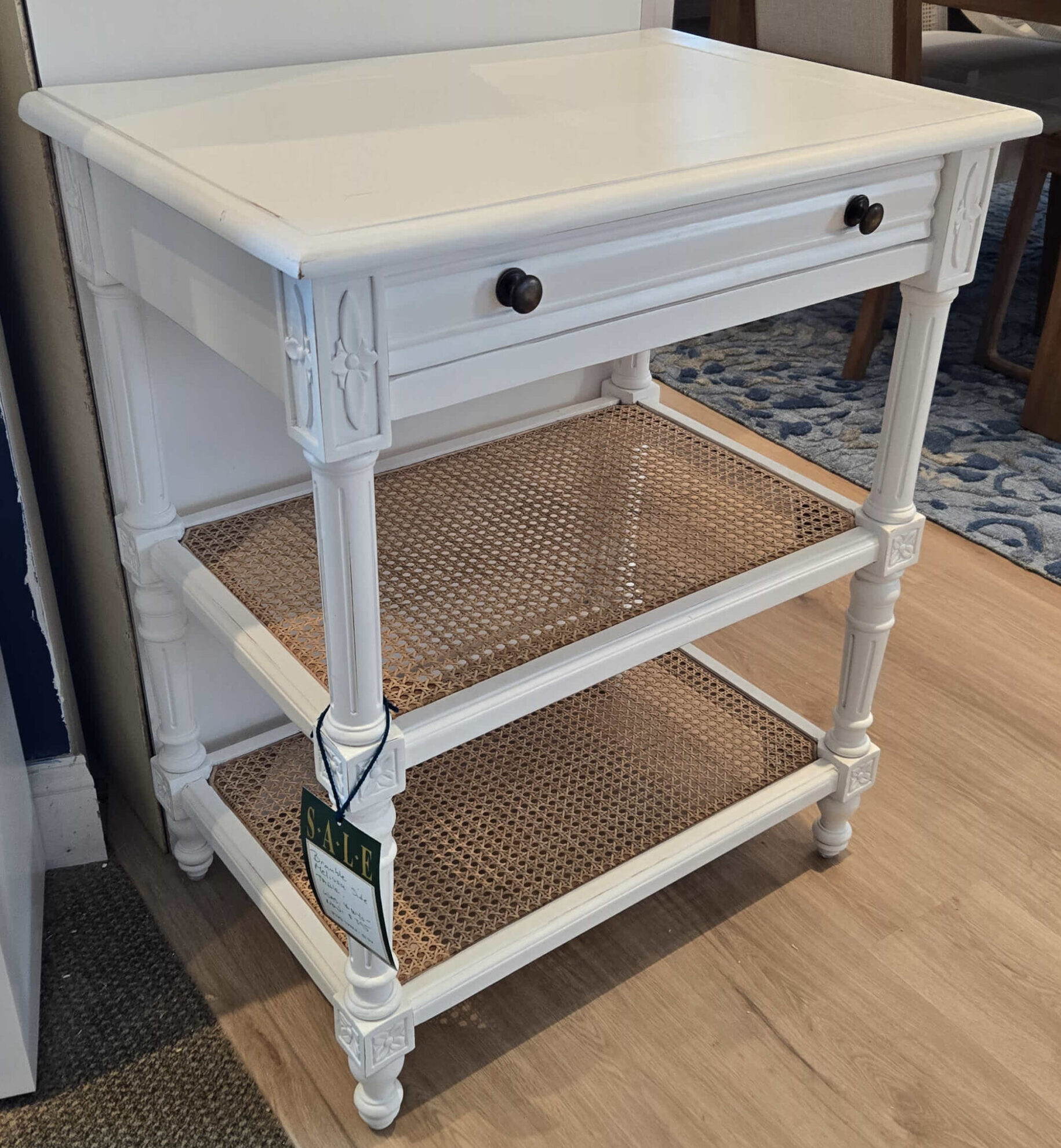 a white cabinet sitting on top of a wooden floor