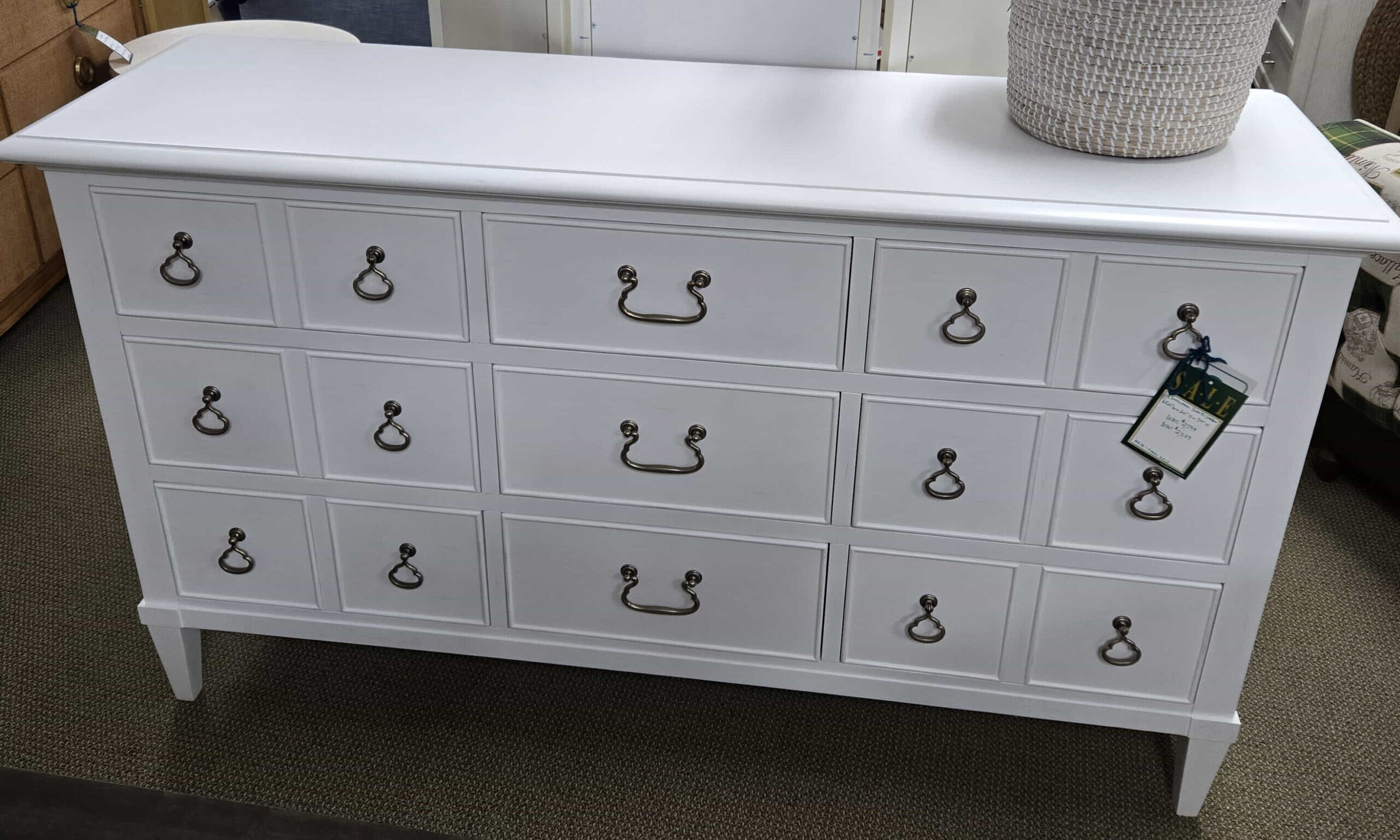 a white dresser with a mirror on top of it