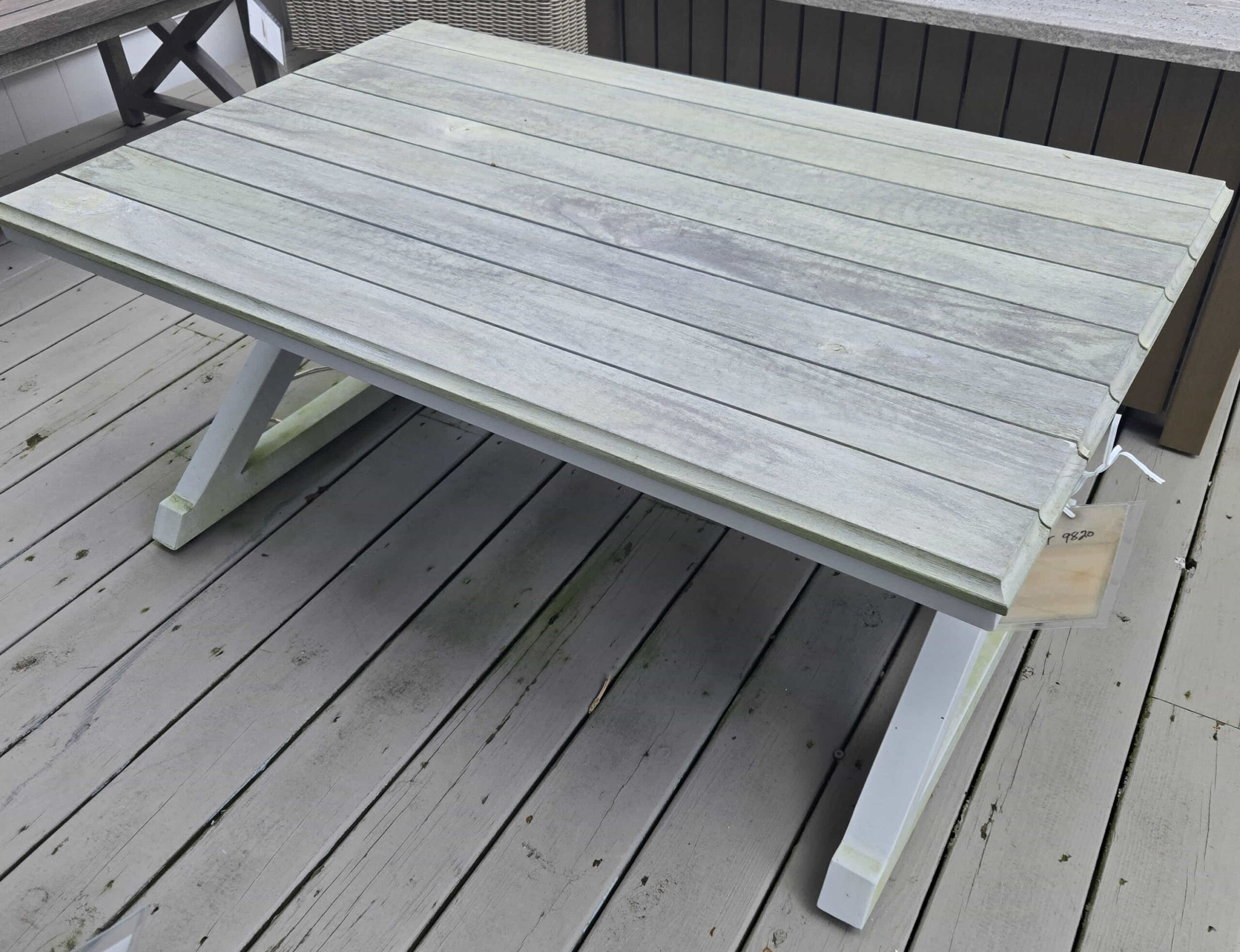 a wooden table sitting on top of a wooden deck