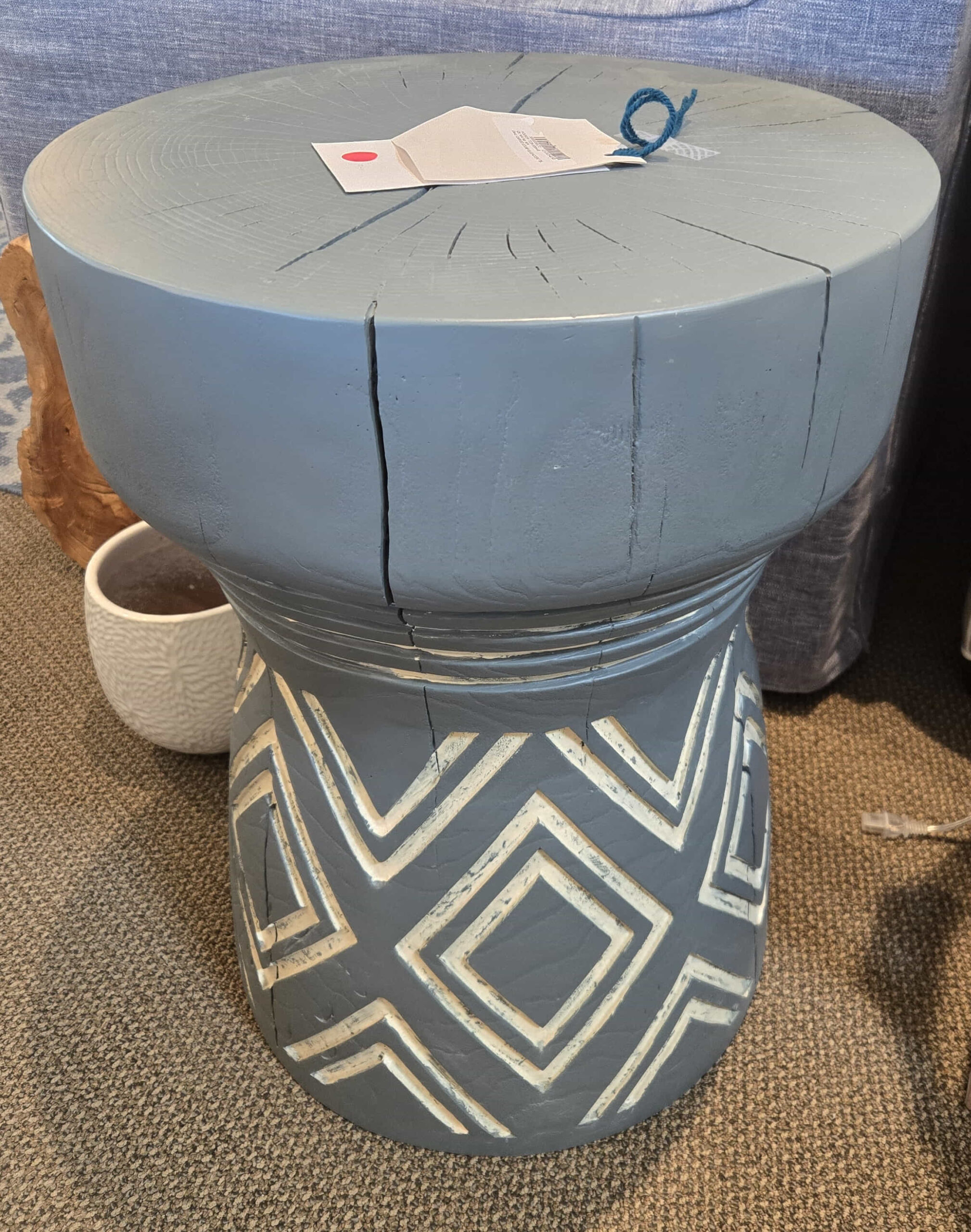 a blue stool with a white design on it