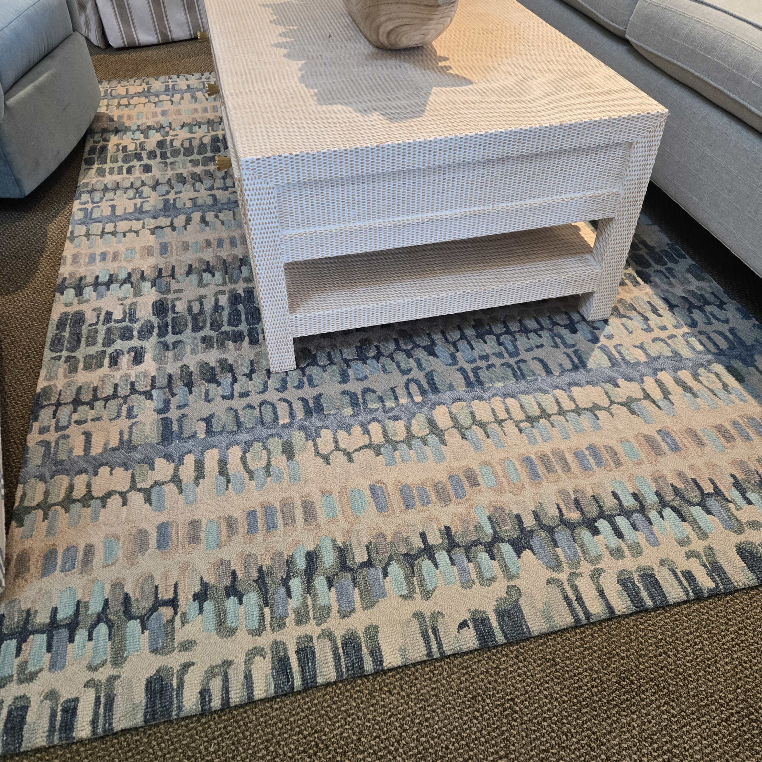 a room with a couch and a rug on the floor