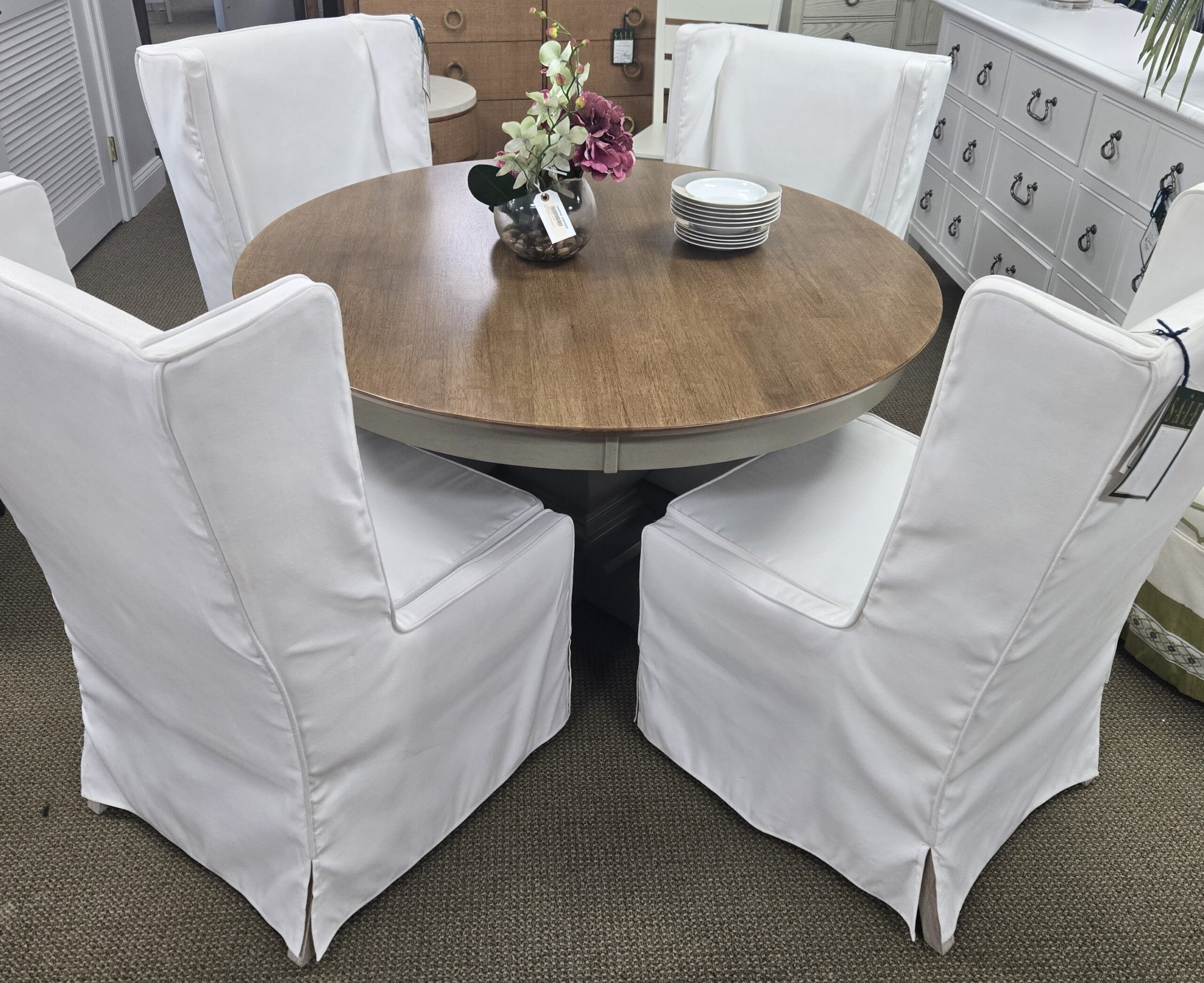 a dining room table with white chairs around it