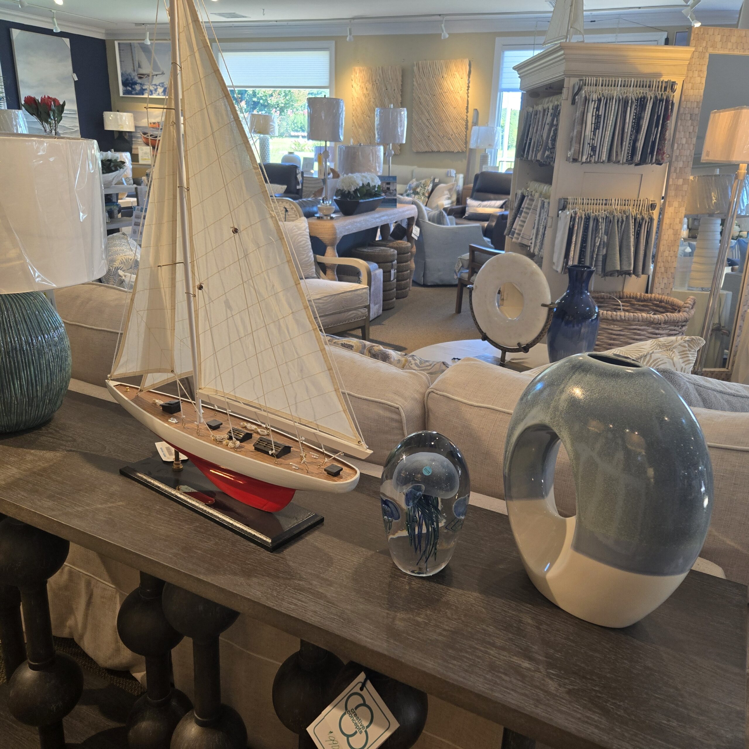 a living room filled with furniture and a sail boat