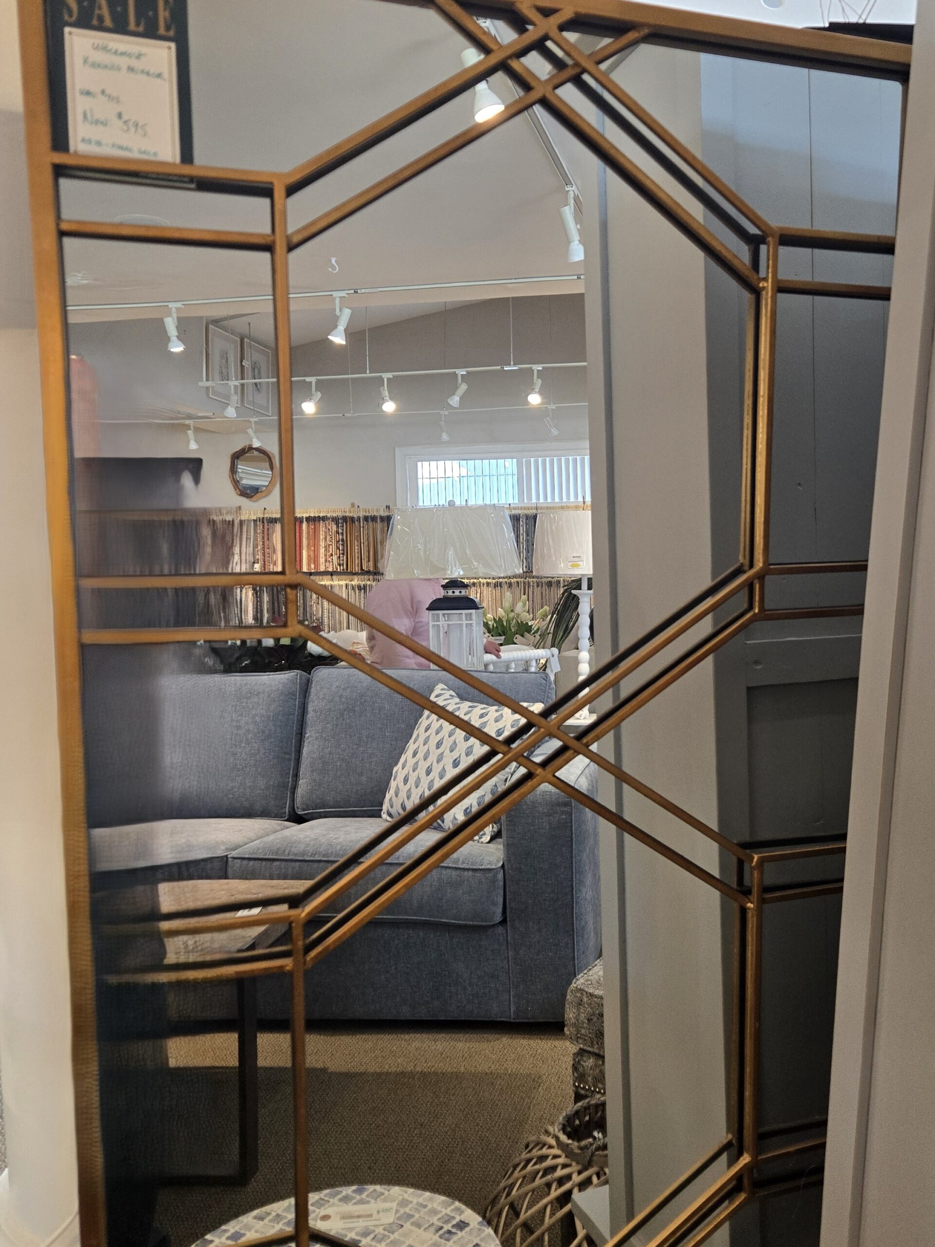 a living room with a couch and a mirror