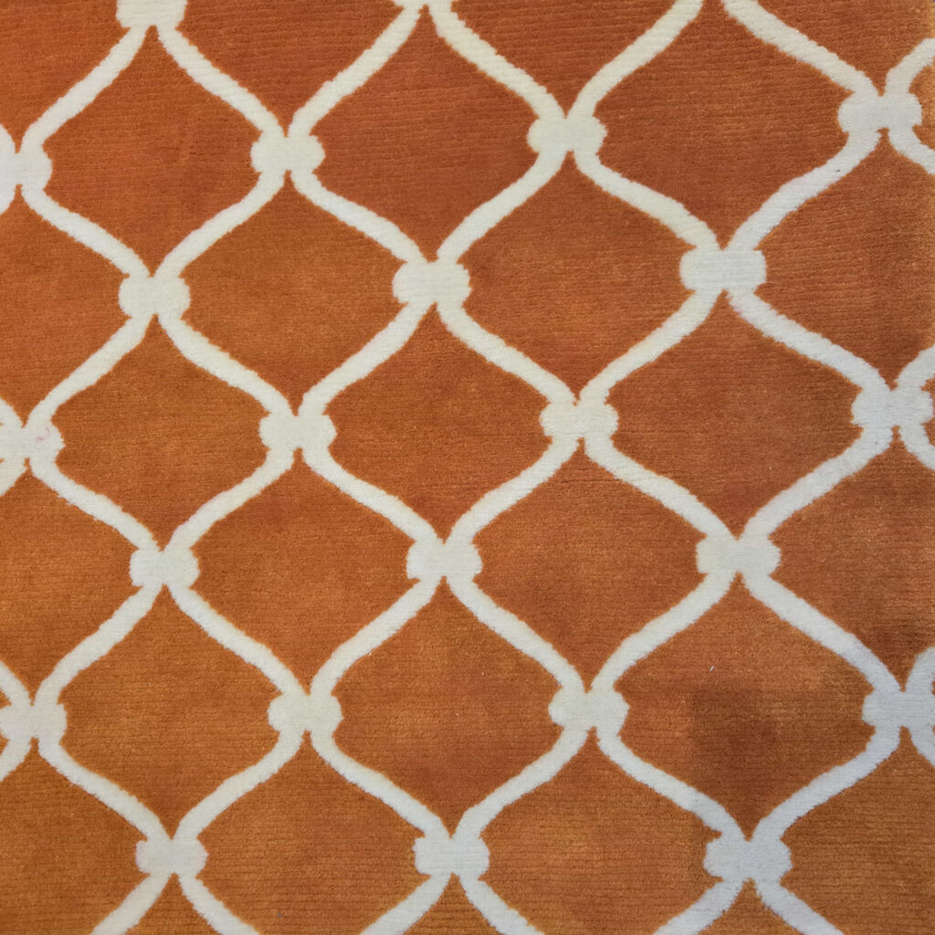Thumbnail of http://an%20orange%20rug%20with%20a%20white%20trellis%20pattern