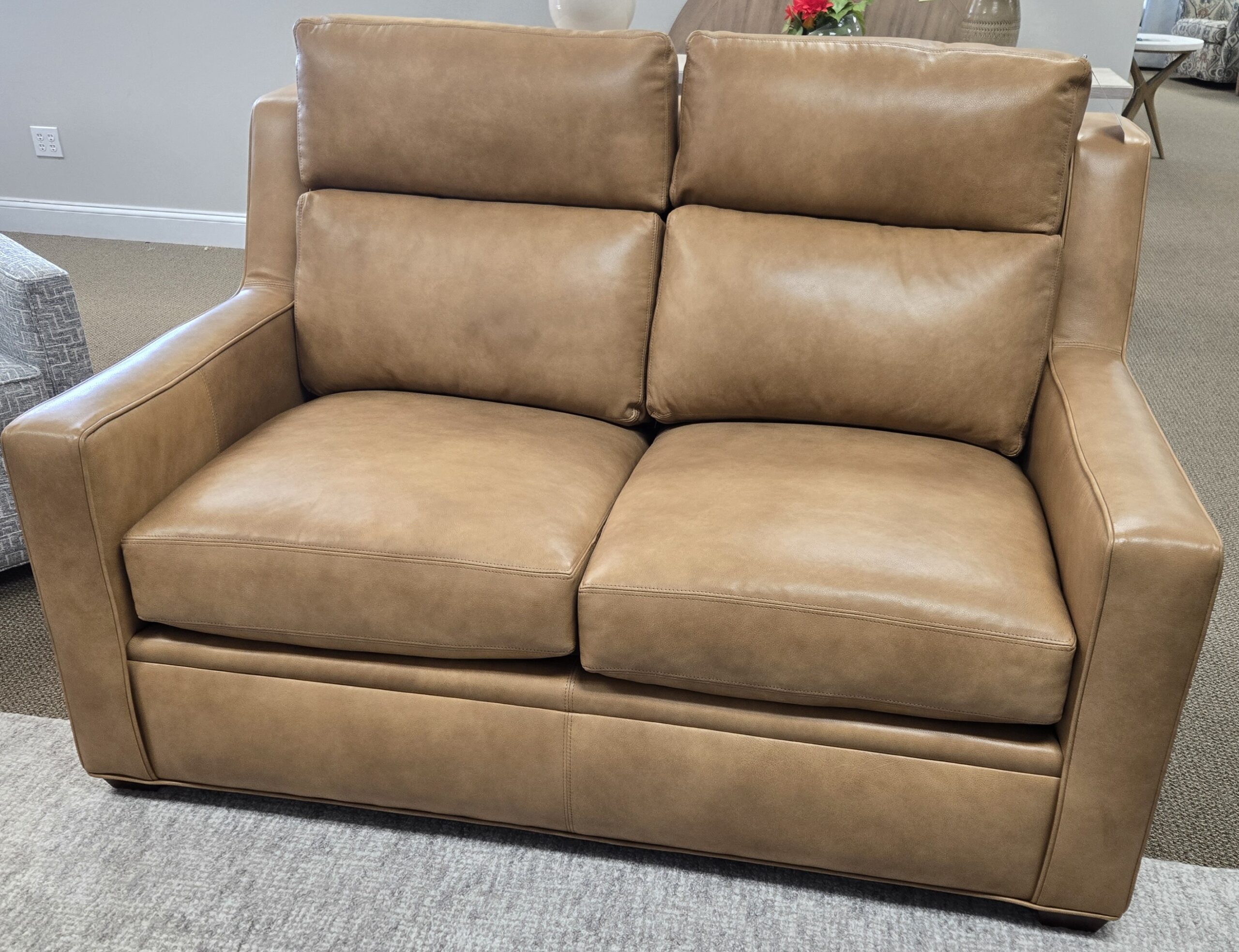 a tan leather couch in a living room