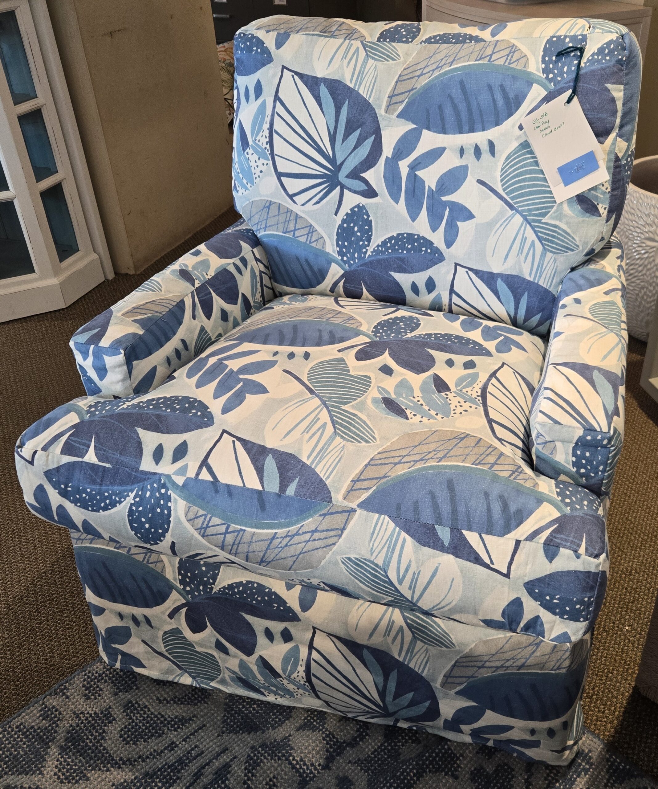 a blue and white chair sitting in a living room