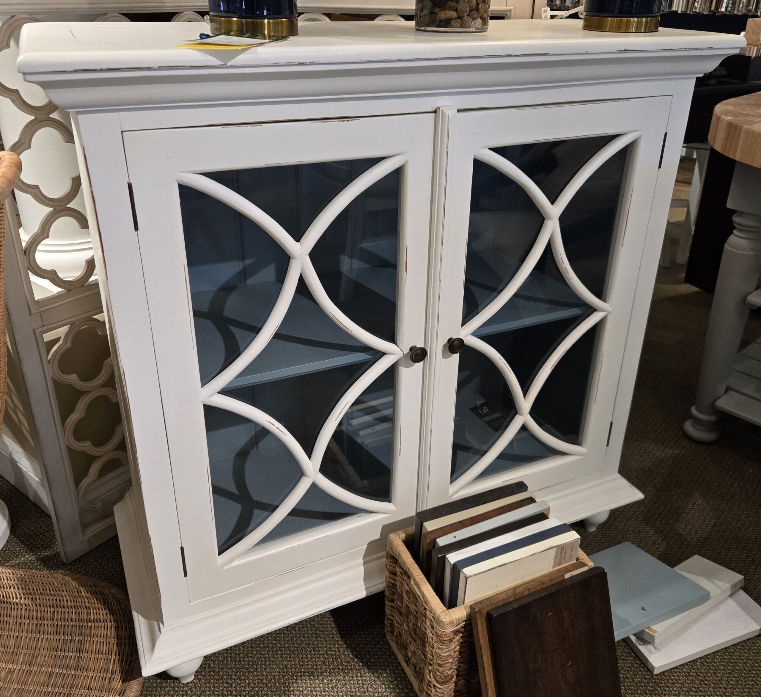 a white cabinet with glass doors in a room