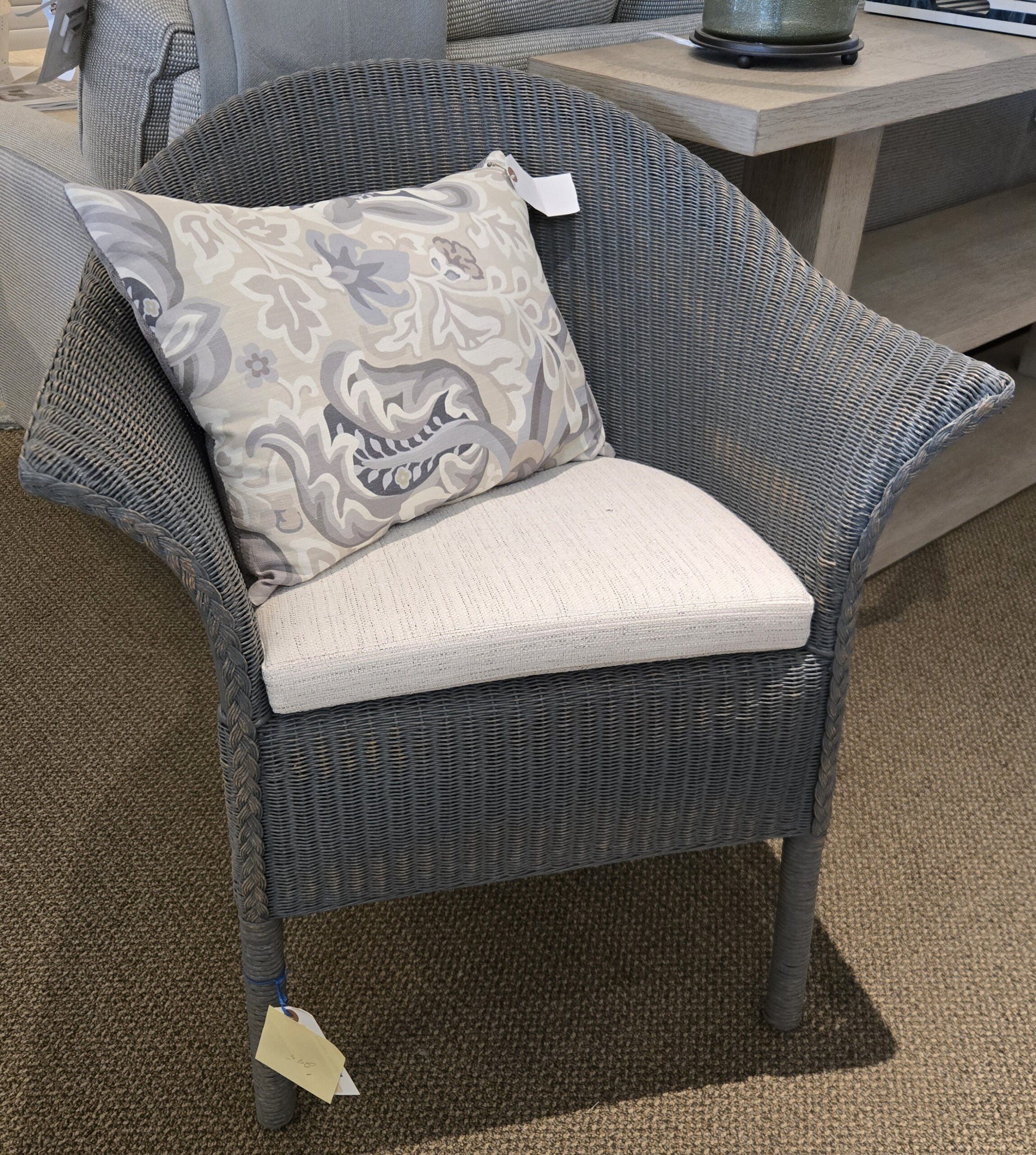 a chair with a pillow on it in a room