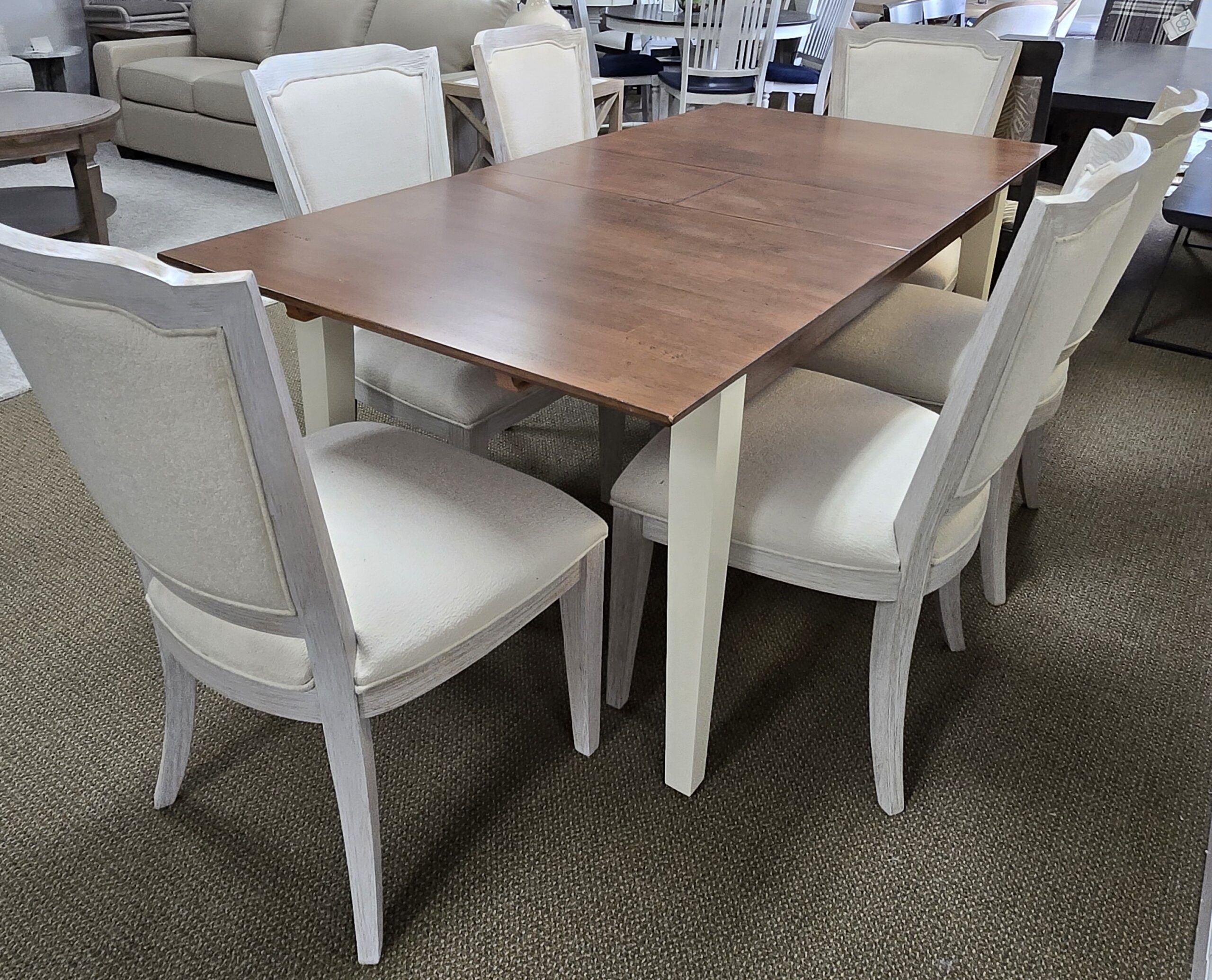 a table with chairs and a couch in a room