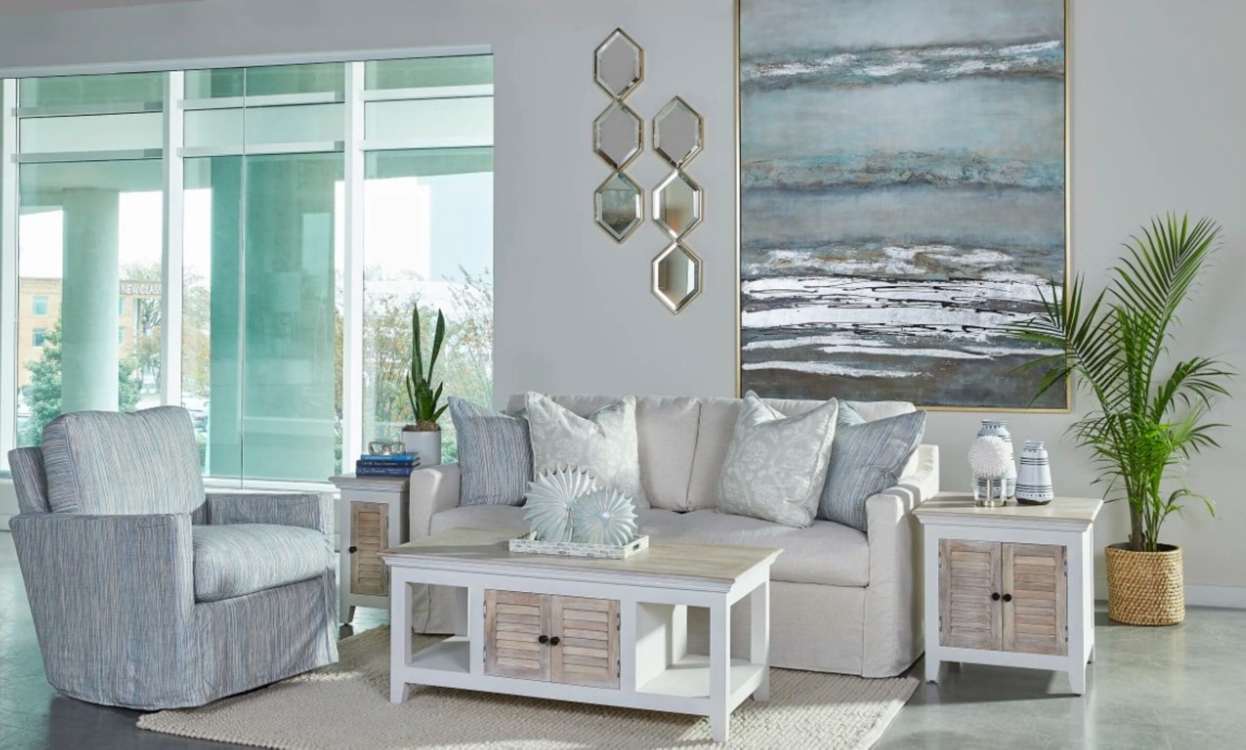 a living room filled with furniture and a painting on the wall