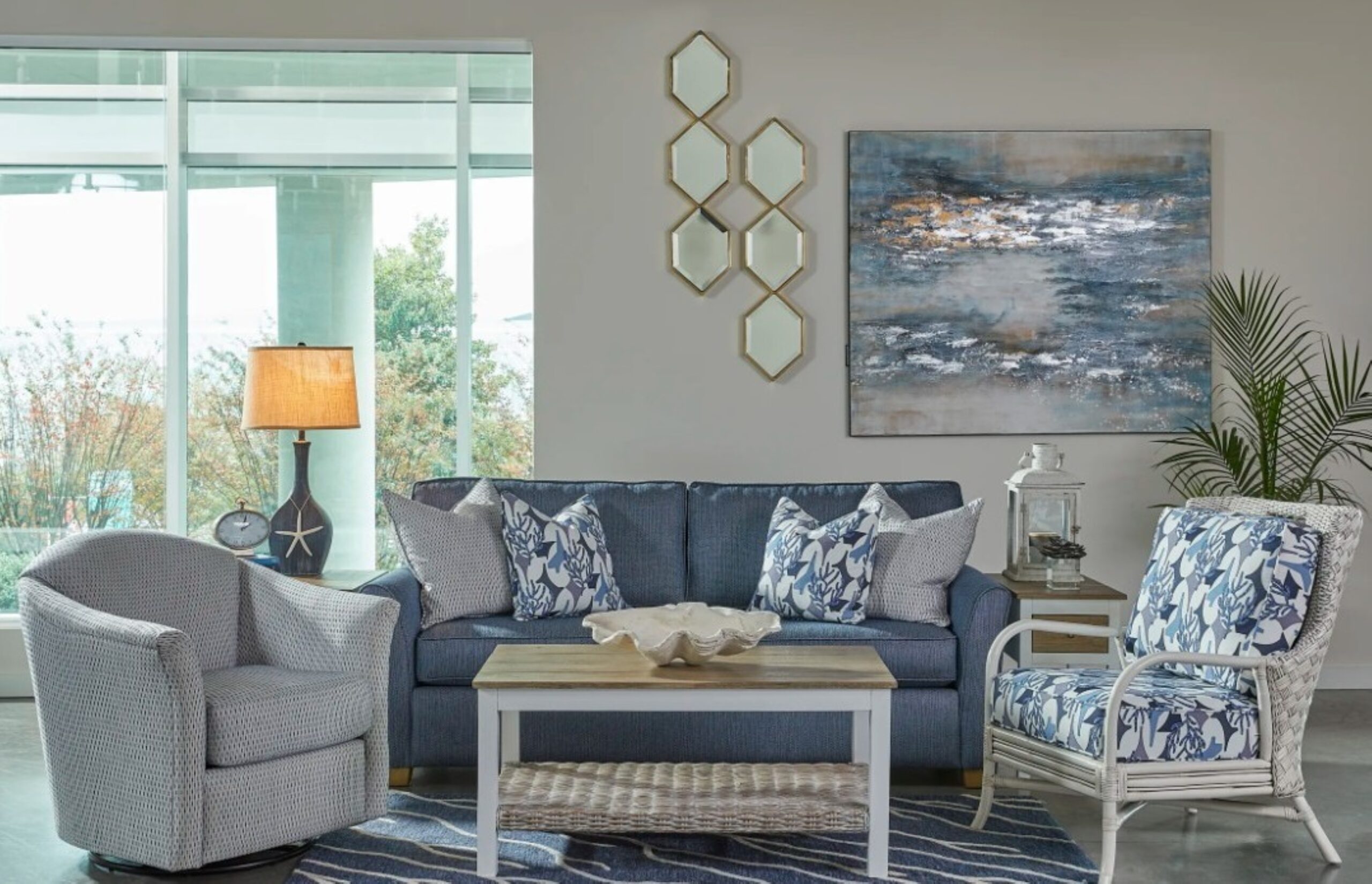 a living room filled with furniture and a painting on the wall