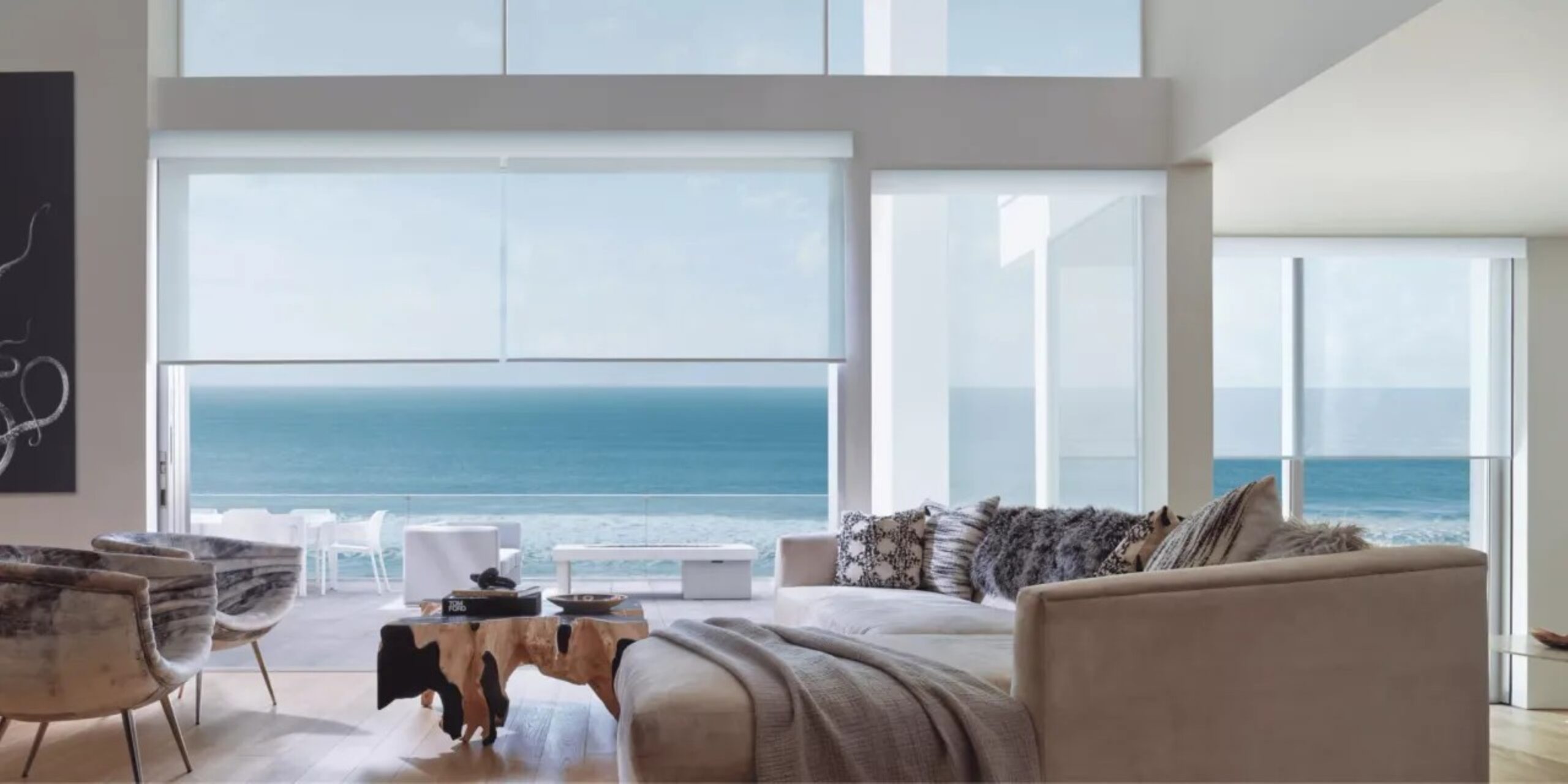 a living room filled with furniture and large windows