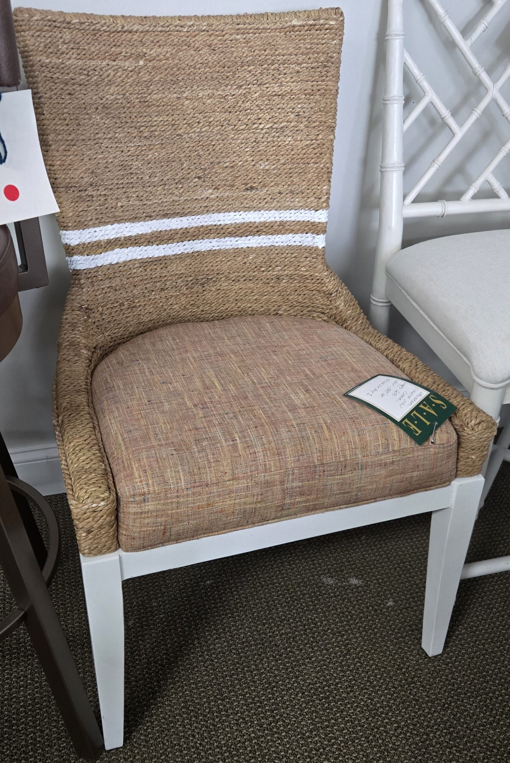 a white chair with a brown seat next to a white chair