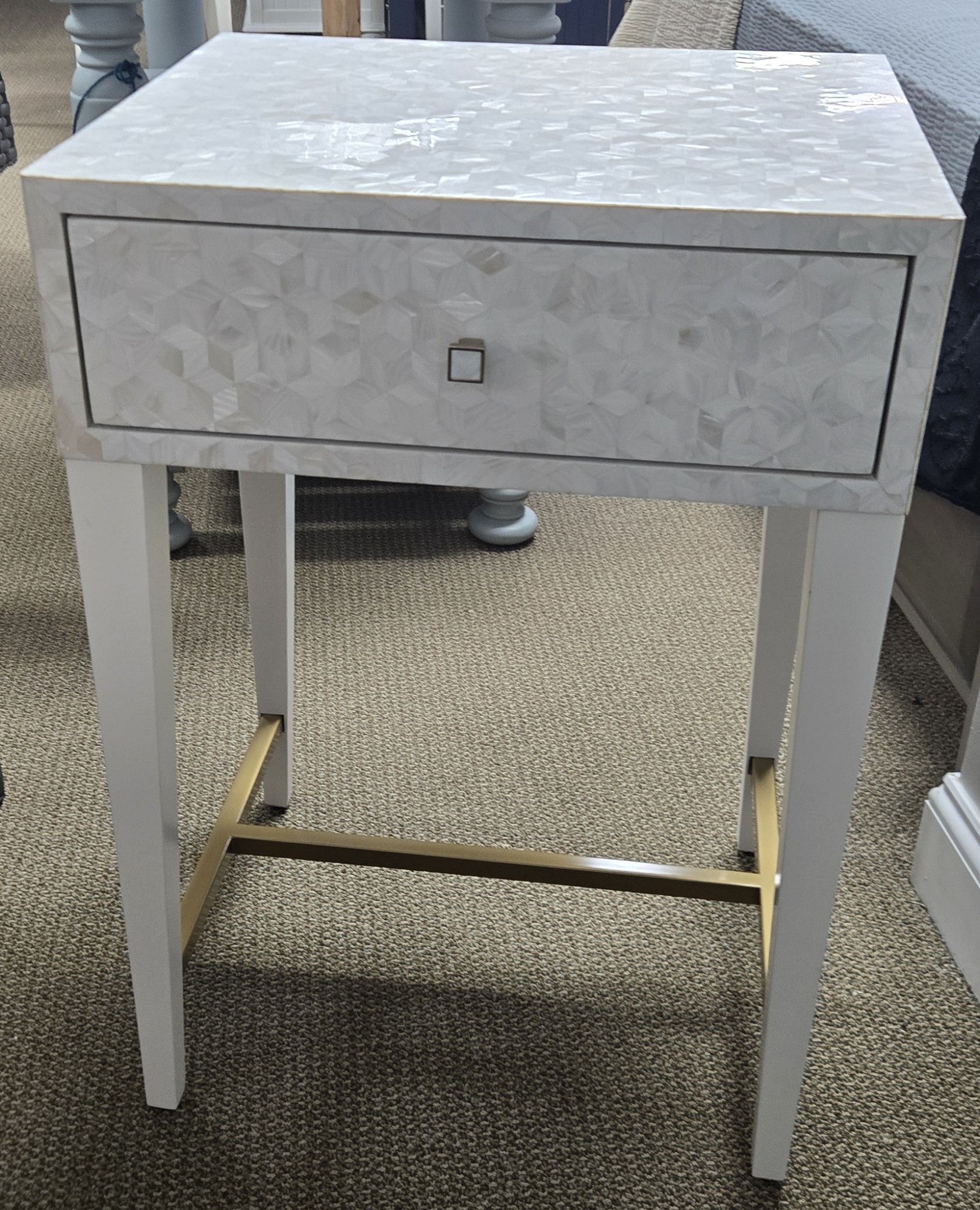 a white table with a drawer on top of it