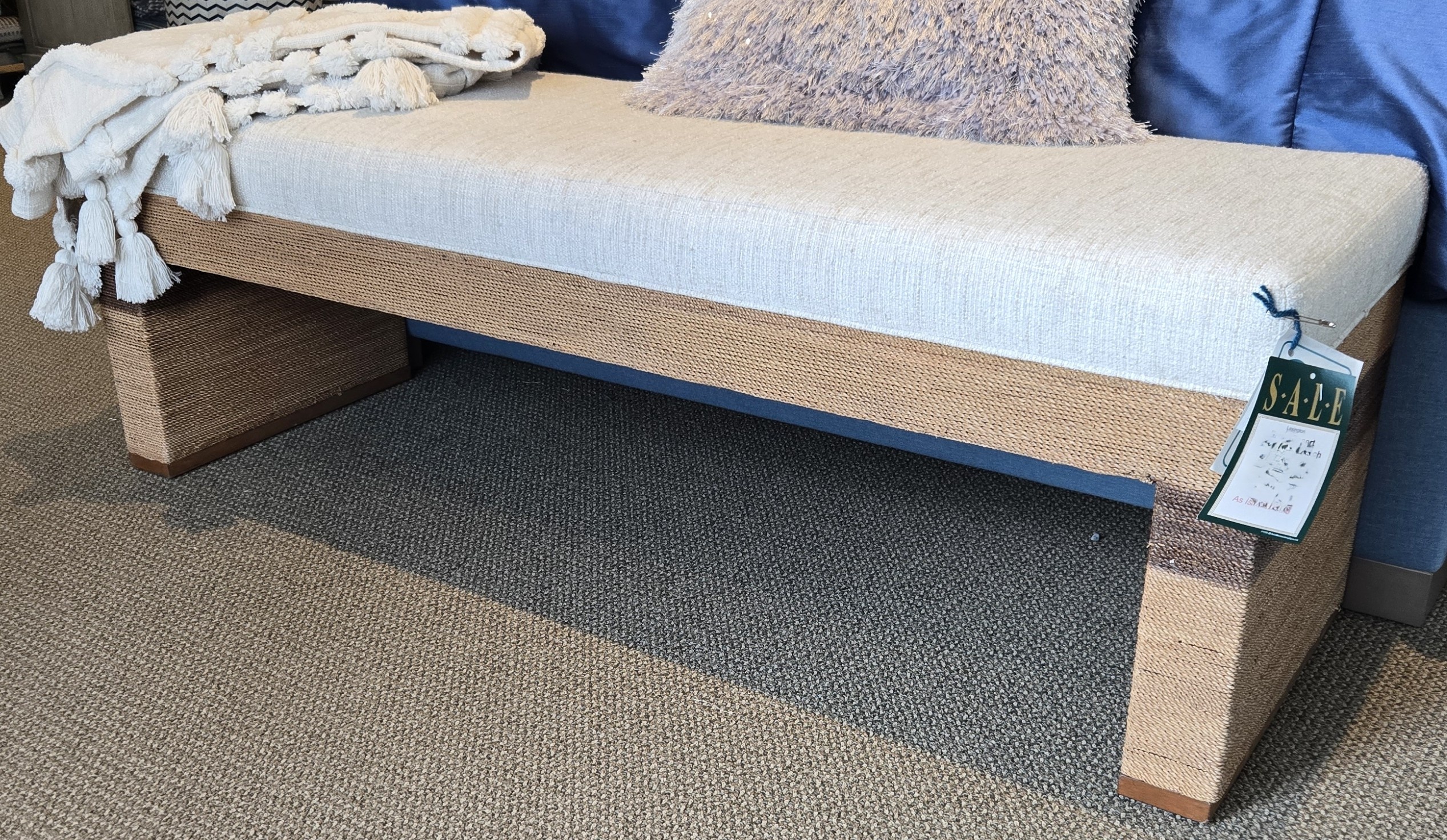 a blue couch with pillows and a blanket on it