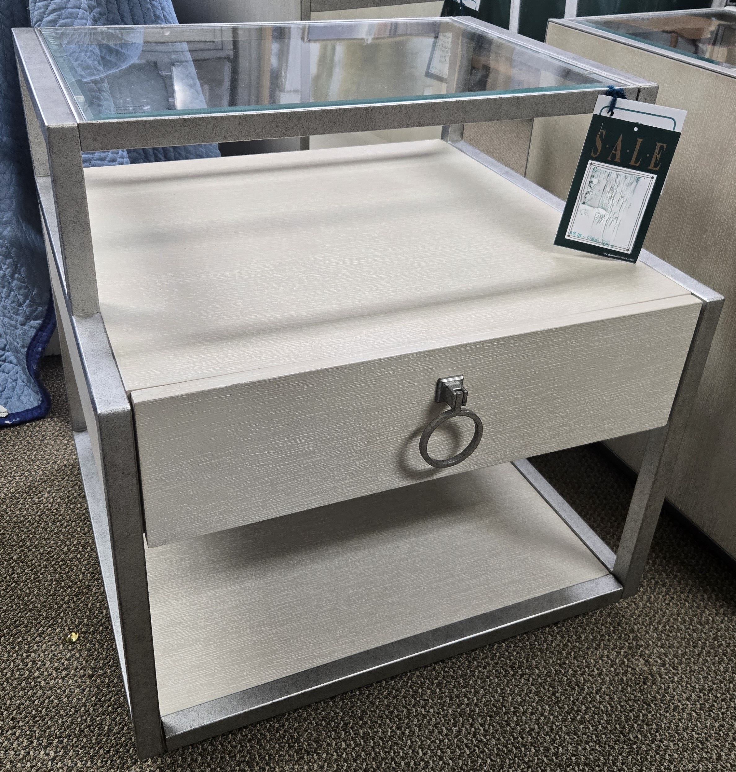 a mirrored side table with a ring on it