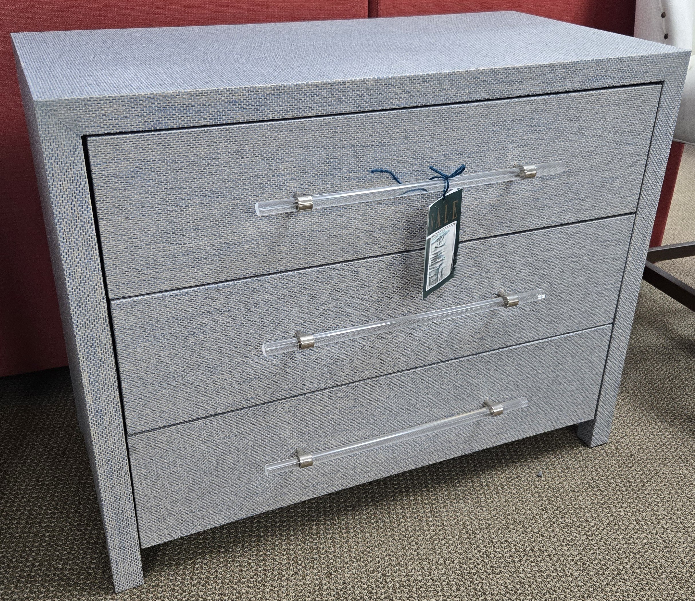 a grey chest of drawers with a tag on it