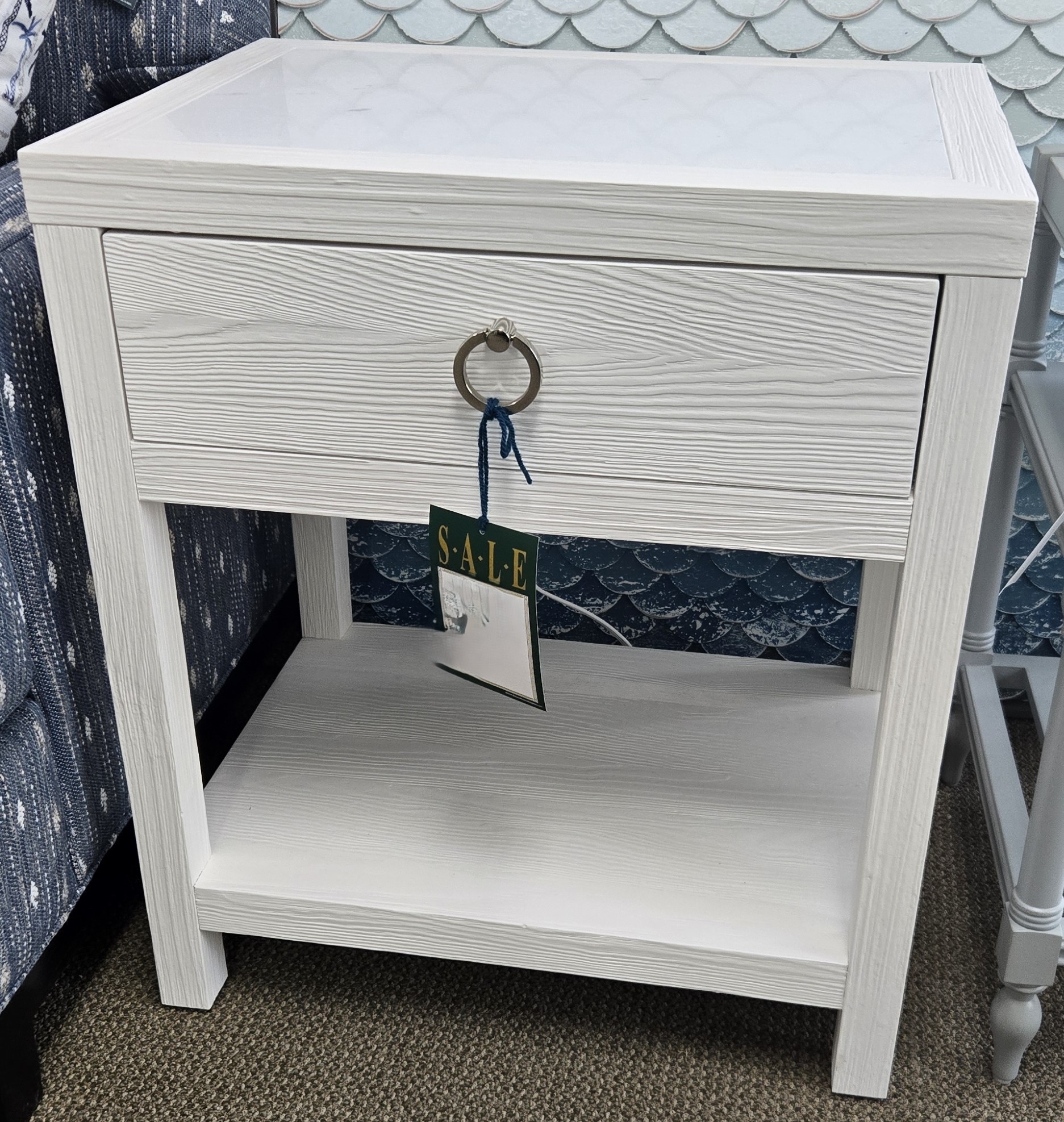 a white night stand with a tag on it