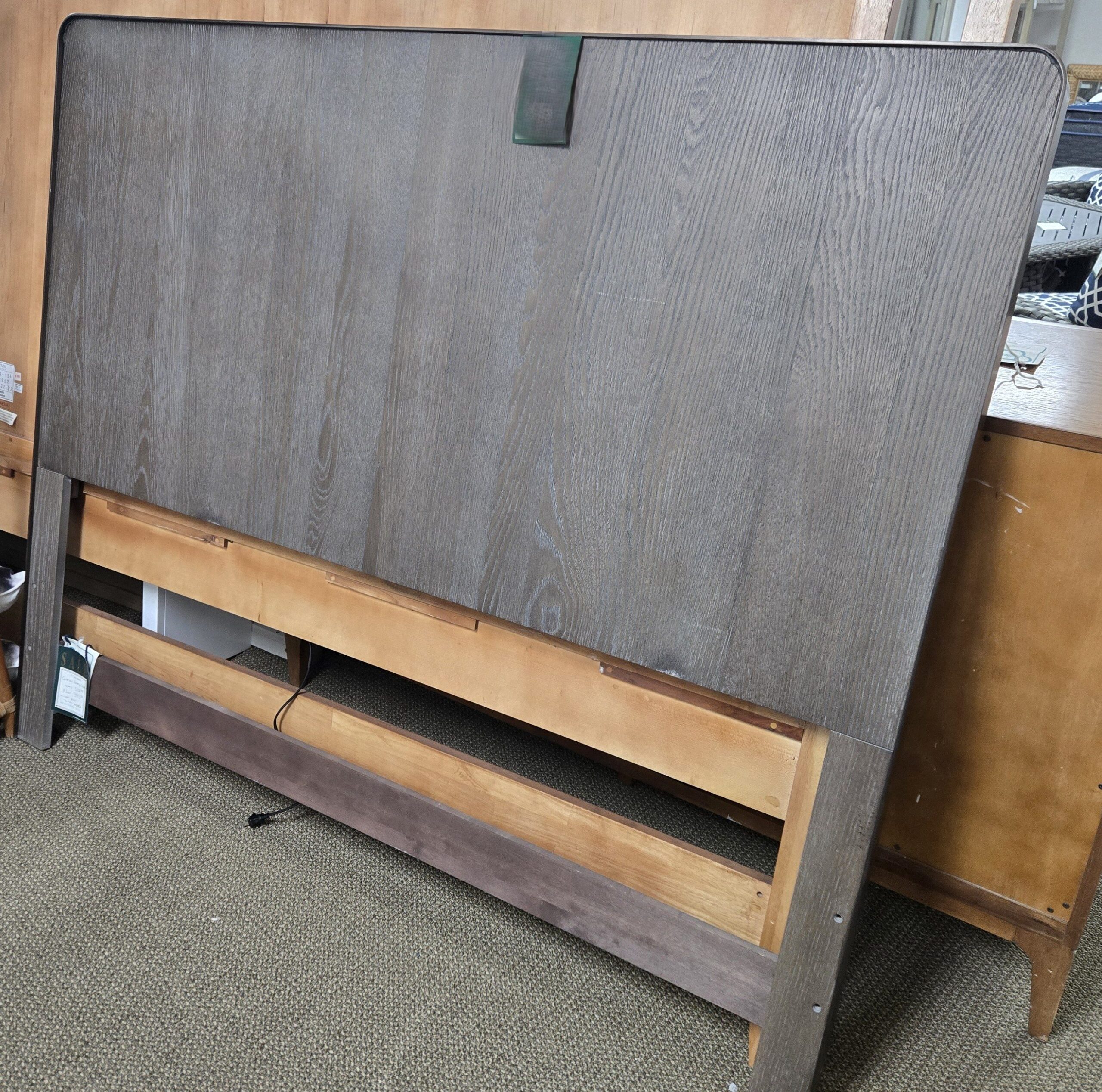 a bed frame with a wooden headboard and foot board