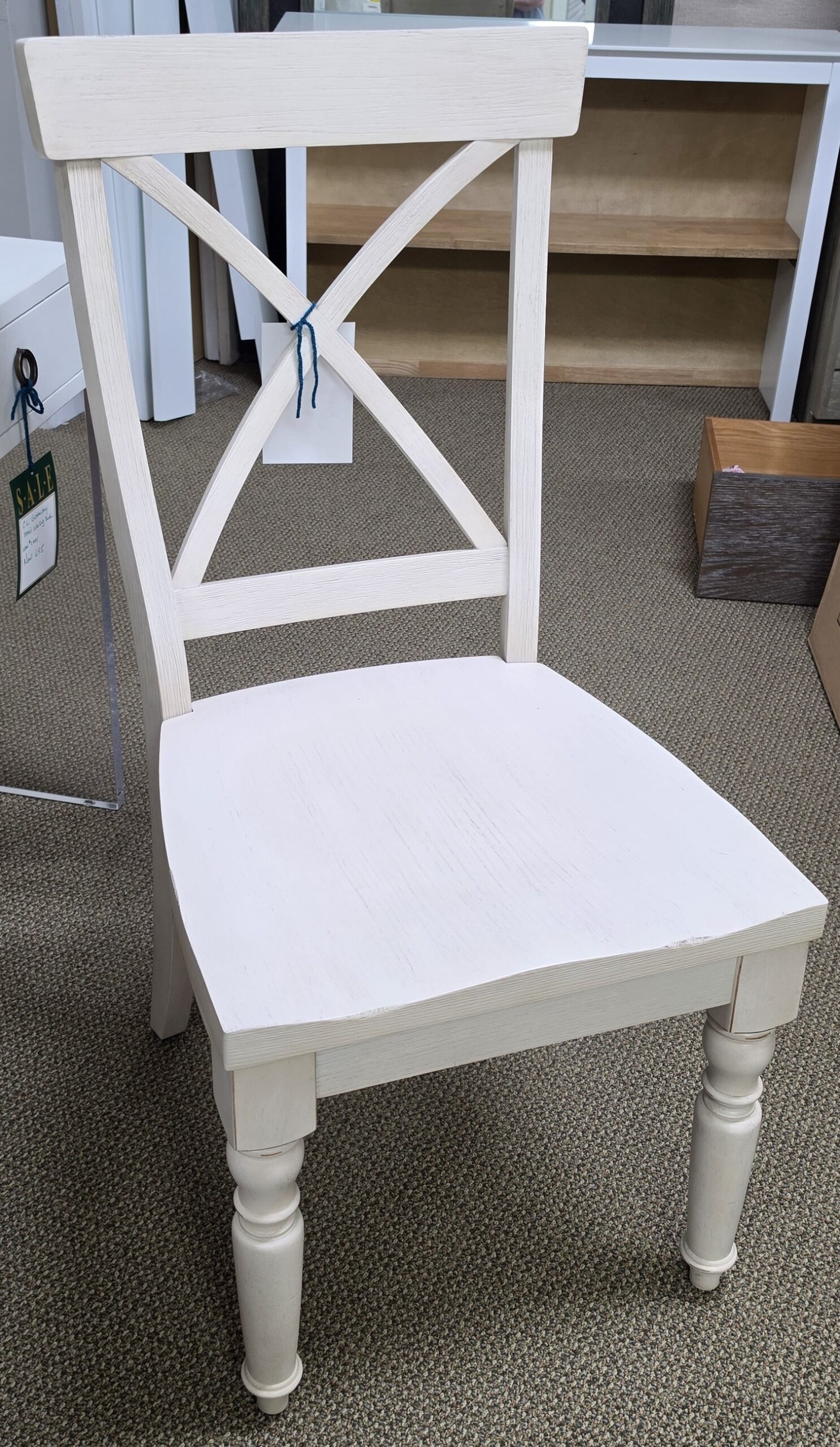 a white chair sitting on top of a carpeted floor