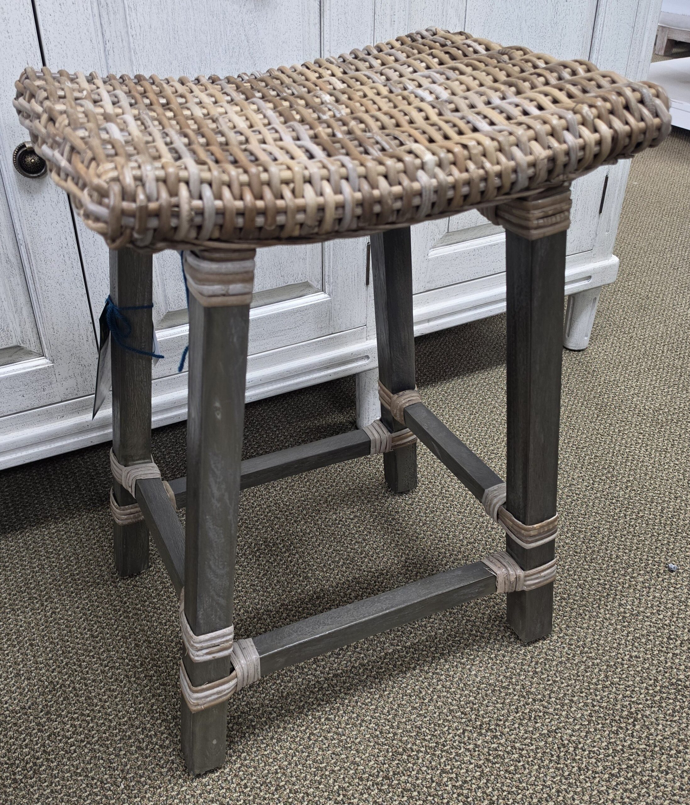 a stool made out of metal and wicker