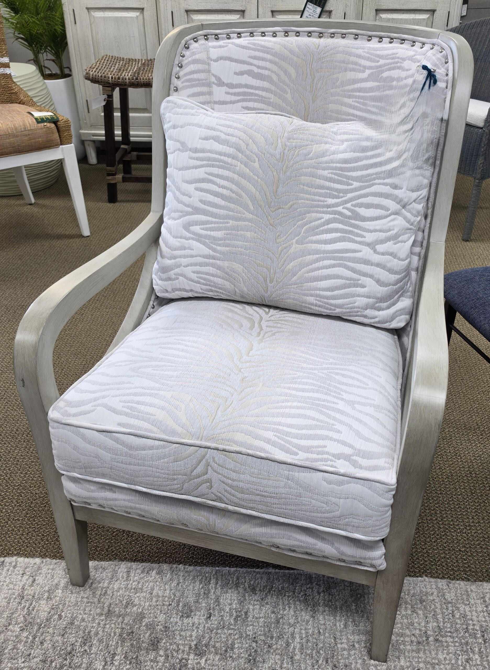 a white chair with a white pillow on top of it