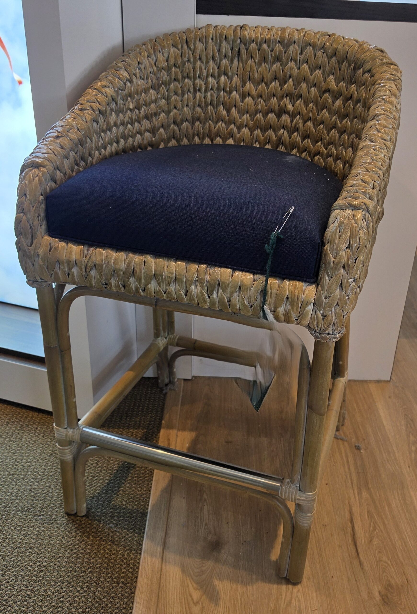 a chair with a blue seat pad on a wooden floor