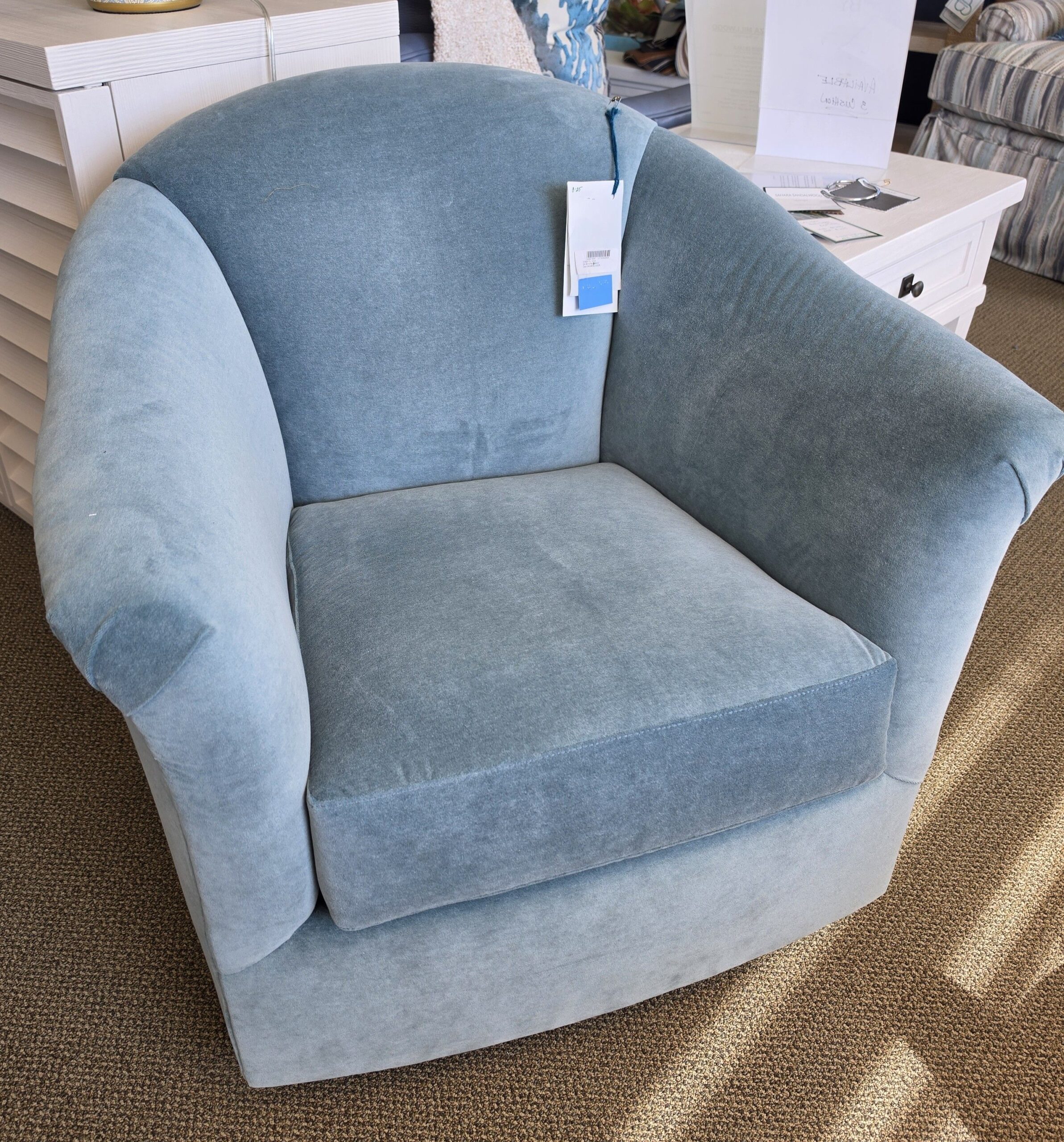 a blue chair sitting on top of a carpeted floor