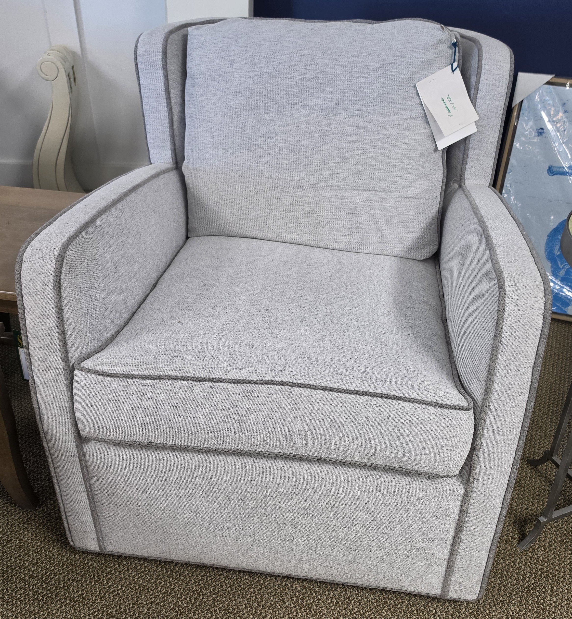 a gray chair with a price tag on it