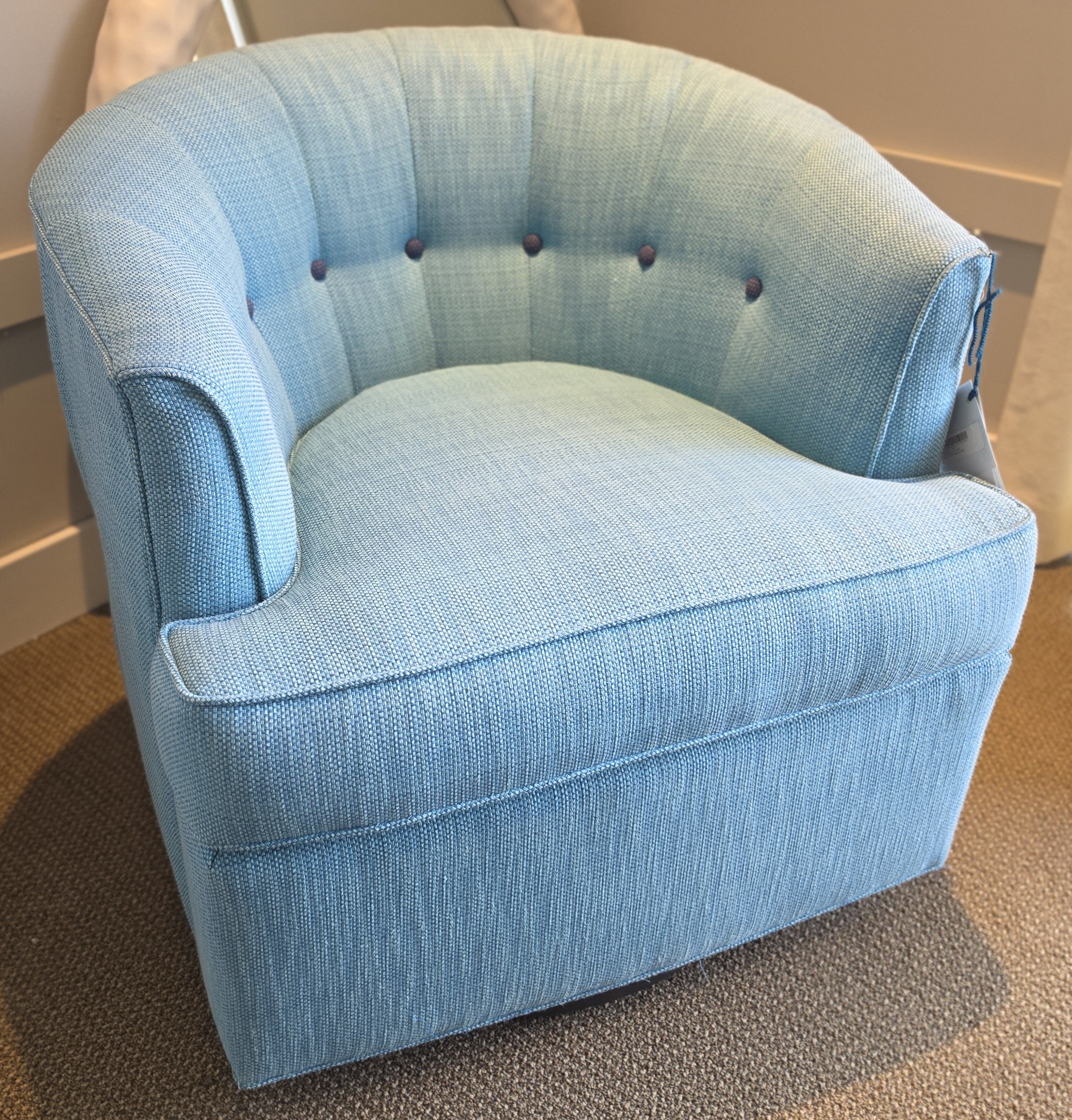 a blue chair sitting in a room next to a mirror