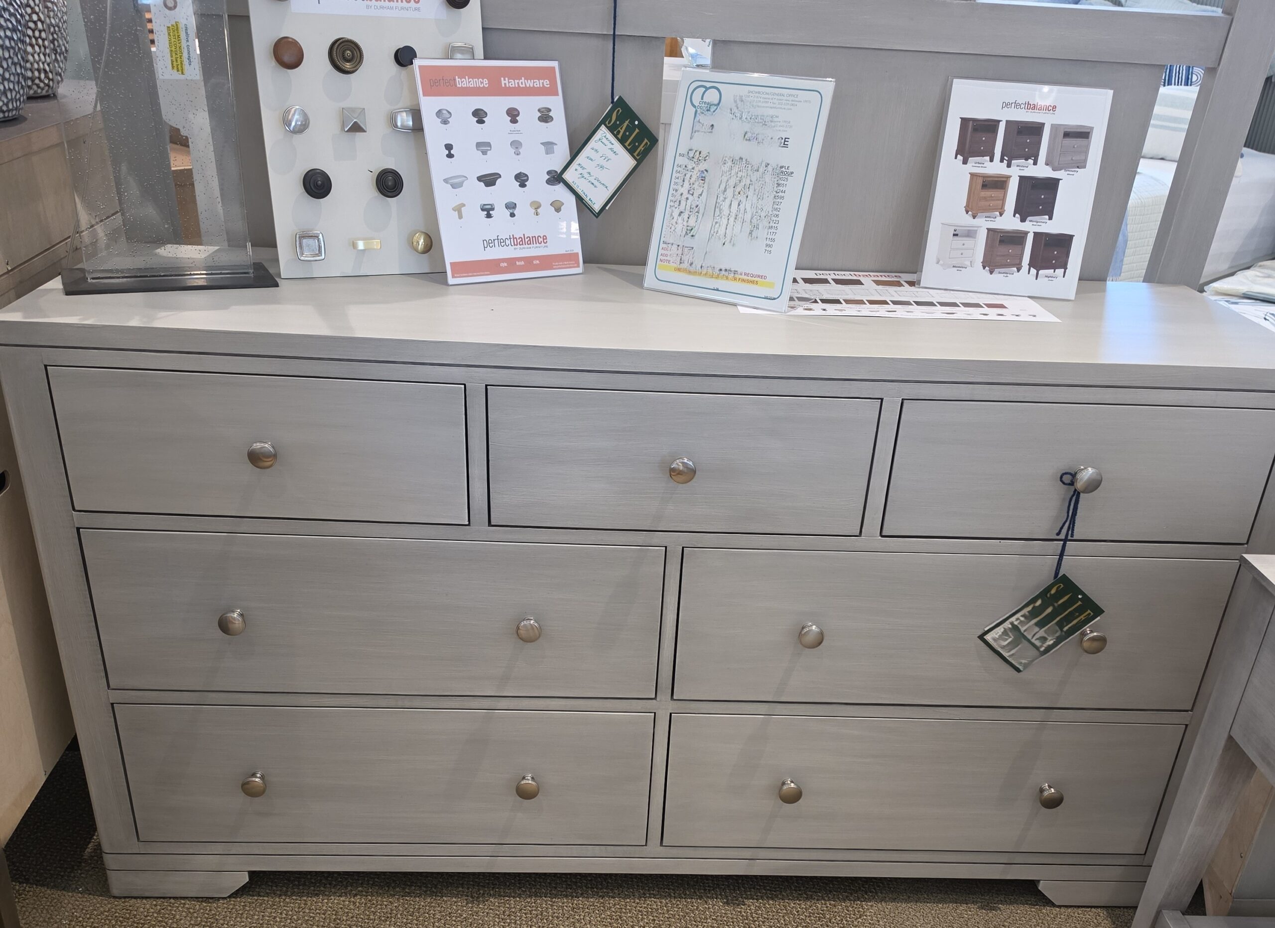 a dresser with drawers and pictures on it