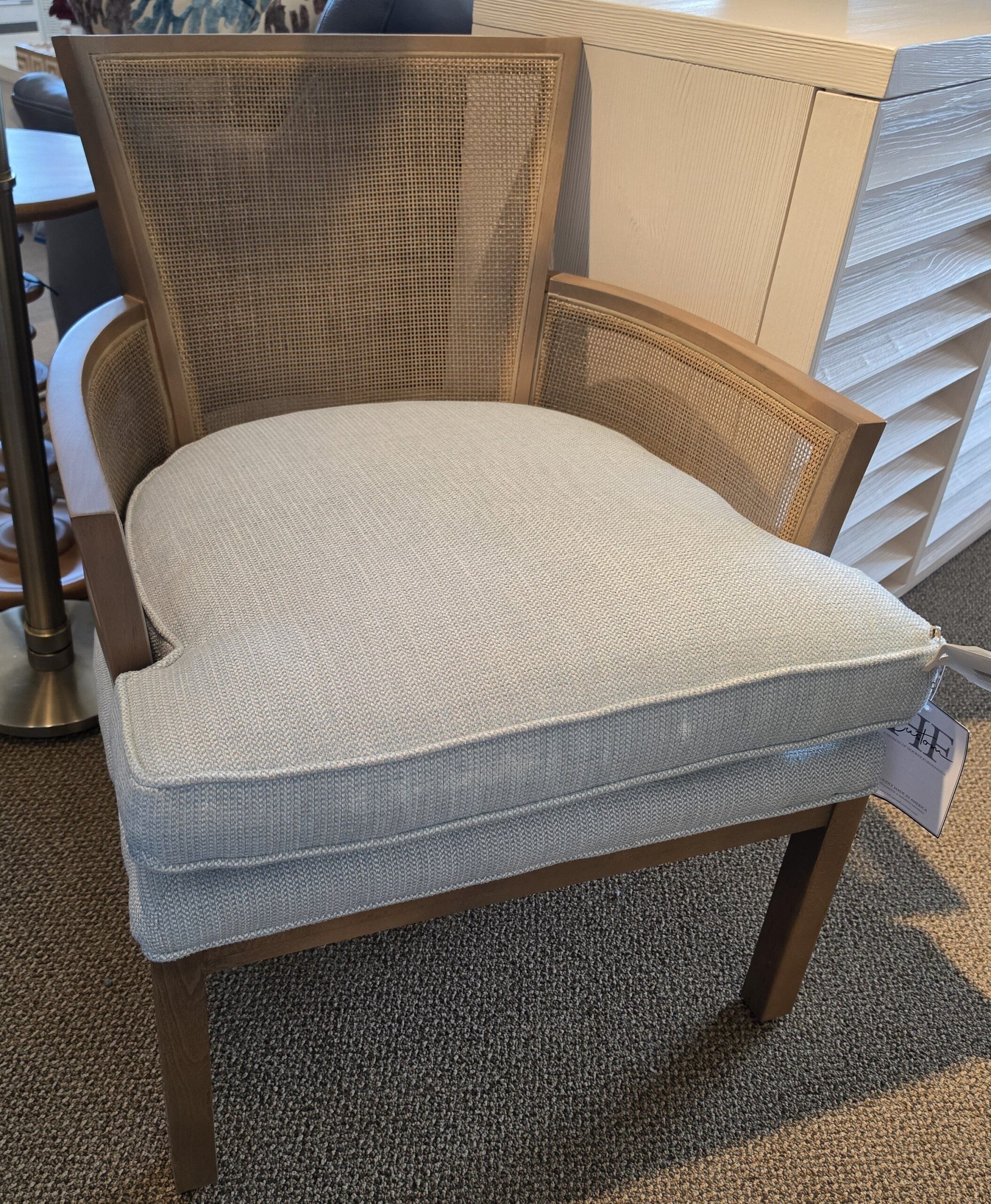a chair with a beige upholstered back and a tan upholstered seat