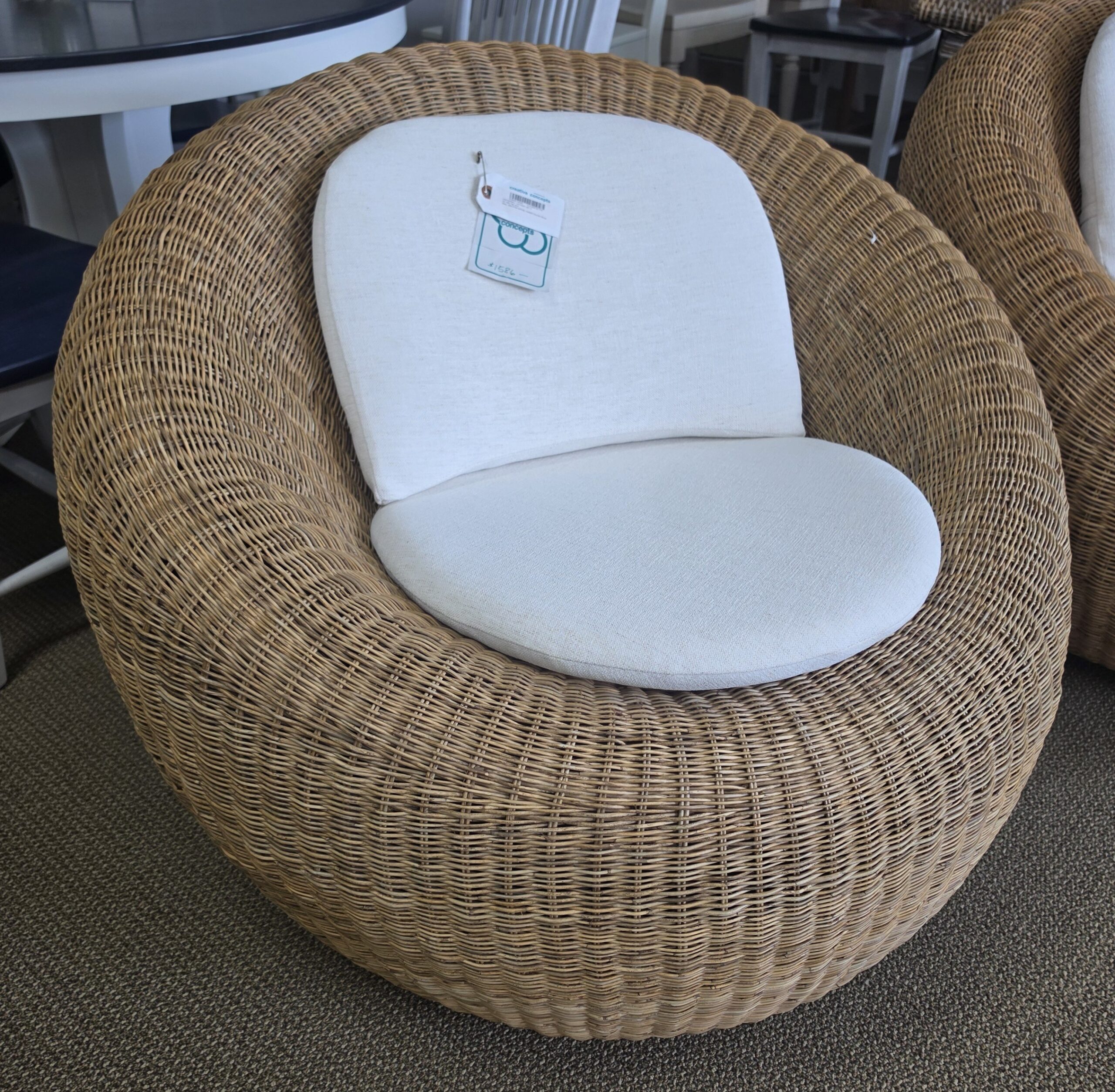 a couple of wicker chairs sitting on top of a rug