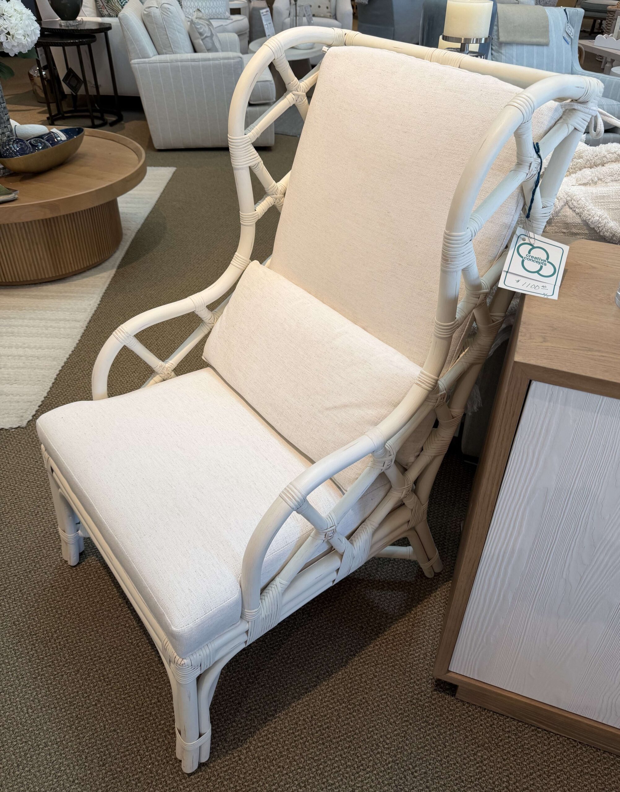 a white chair sitting on top of a floor next to a table