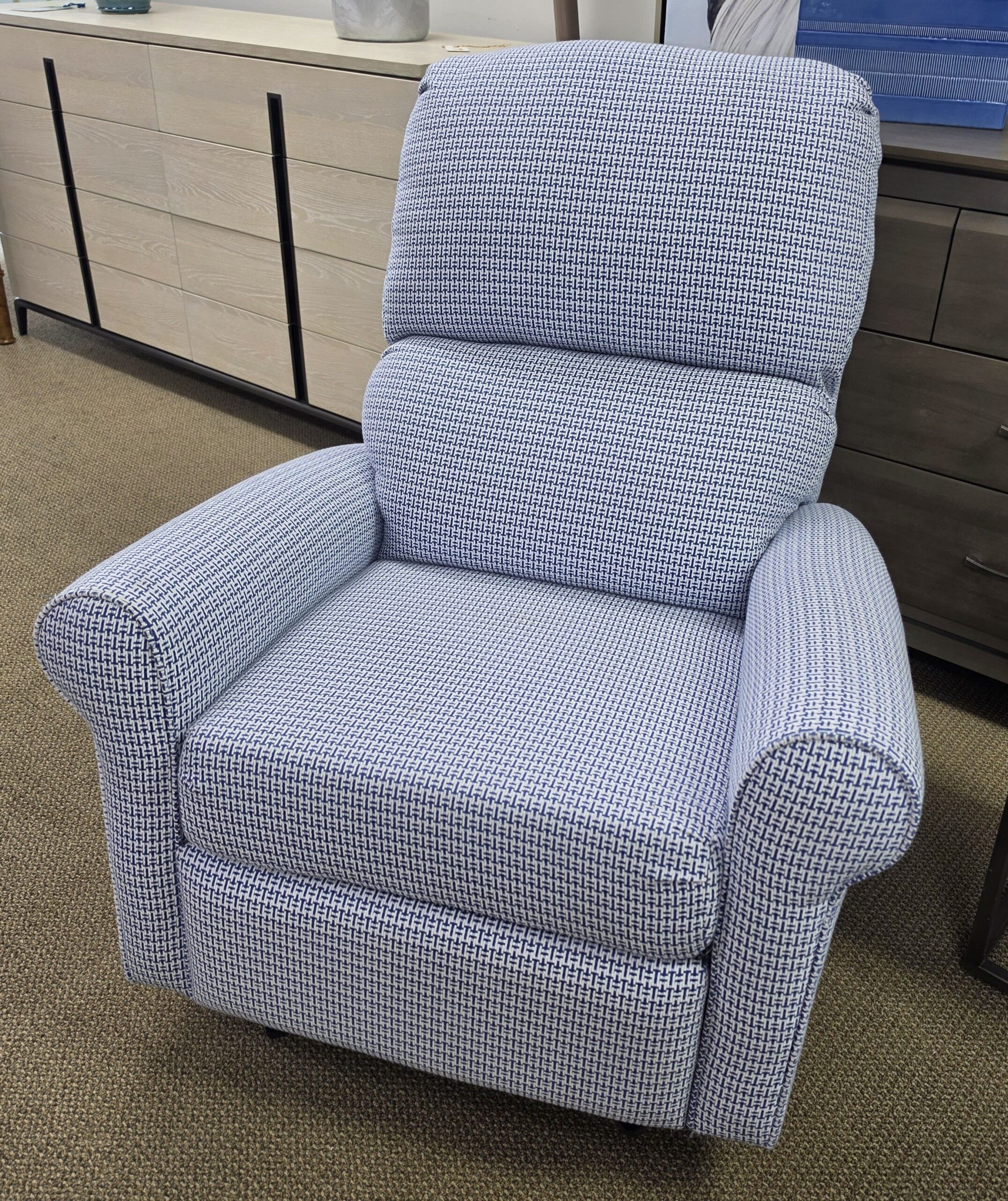 a blue recliner chair sitting in a room
