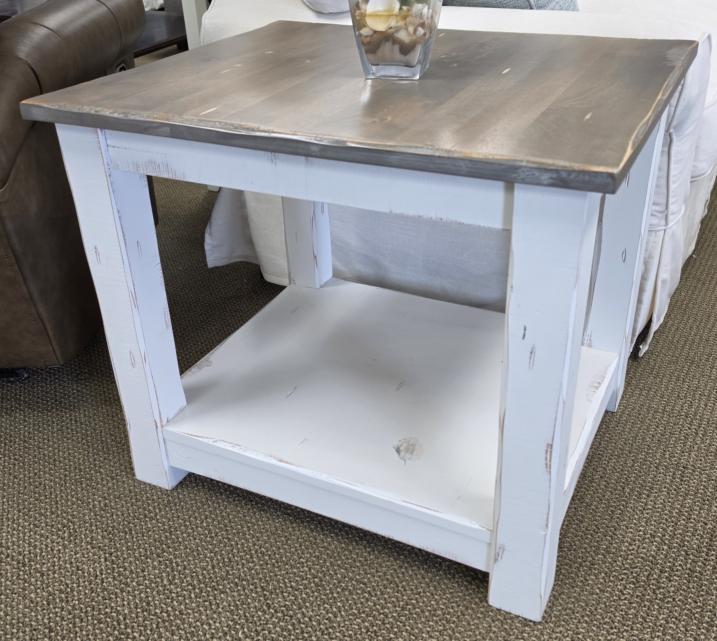 a white table with a glass on top of it