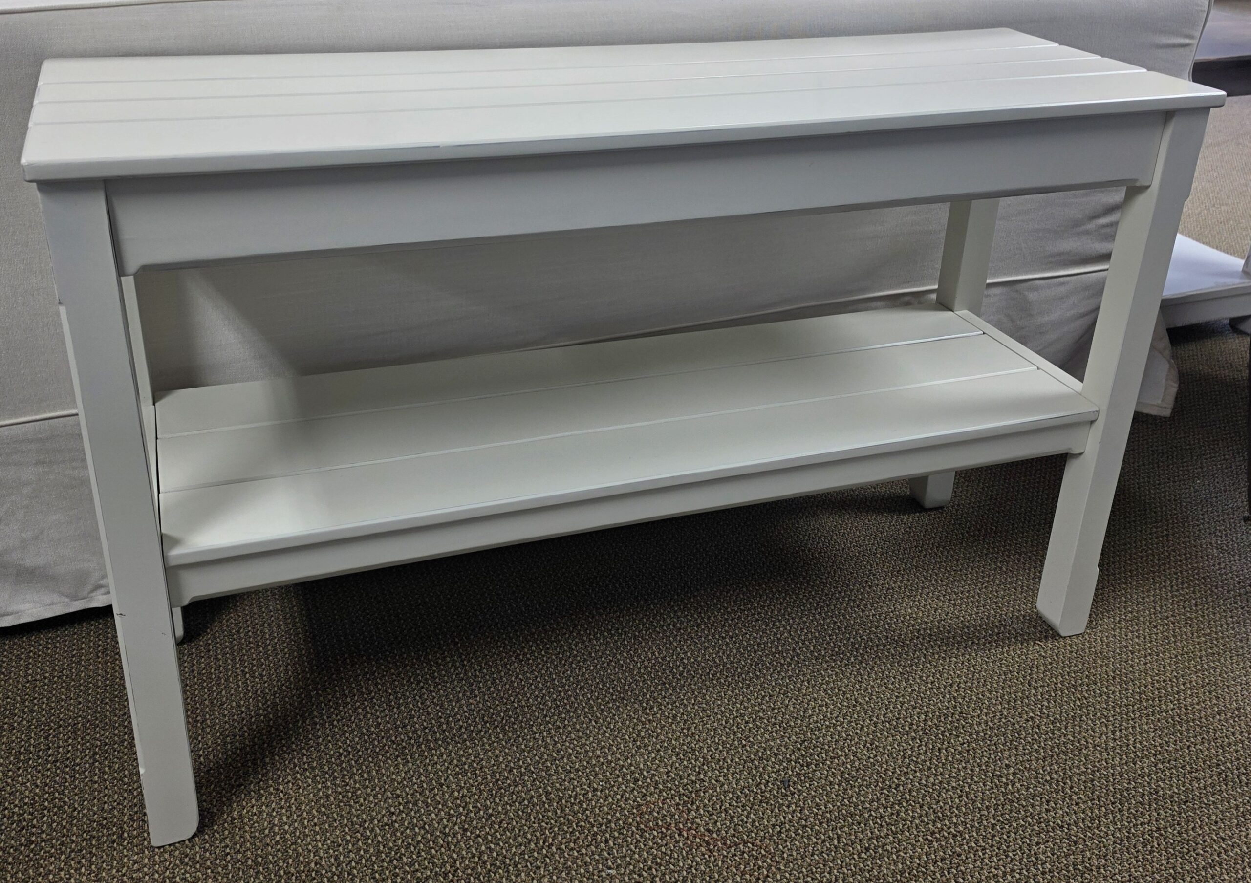 a white table with a shelf on top of it