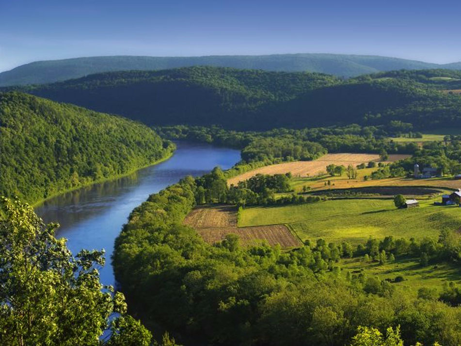 a river running through a lush green valley
